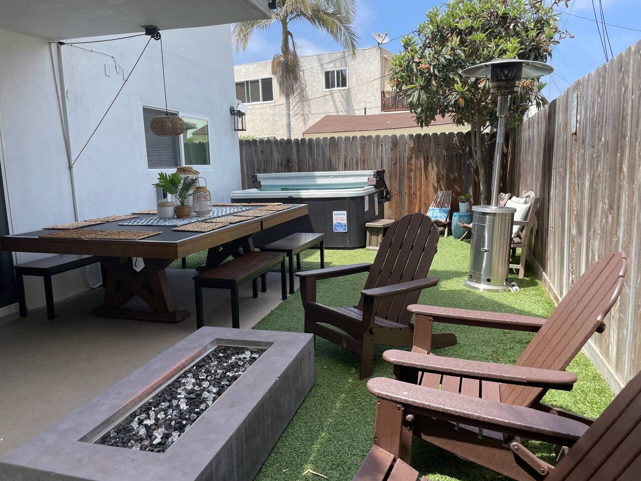 The private back yard has a hot tub, fire pit and a ping pong table that doubles as a dining table that seats 10!