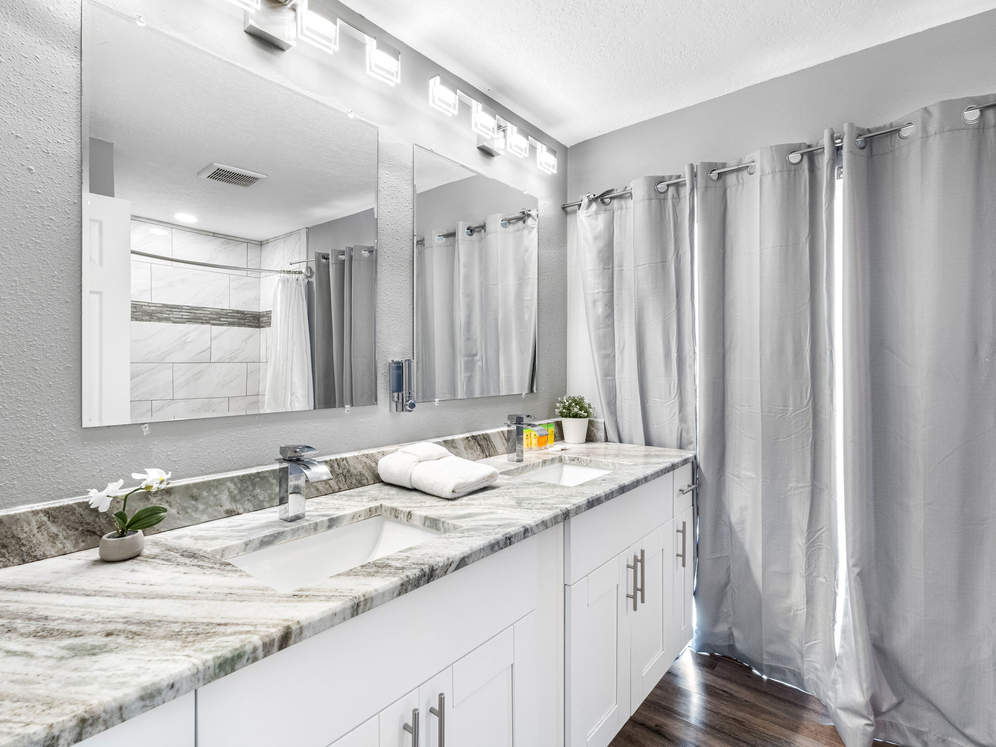 Enjoy the convenience of a stylish double-sink vanity, perfect for couples or shared stays, complete with ample storage and contemporary lighting.