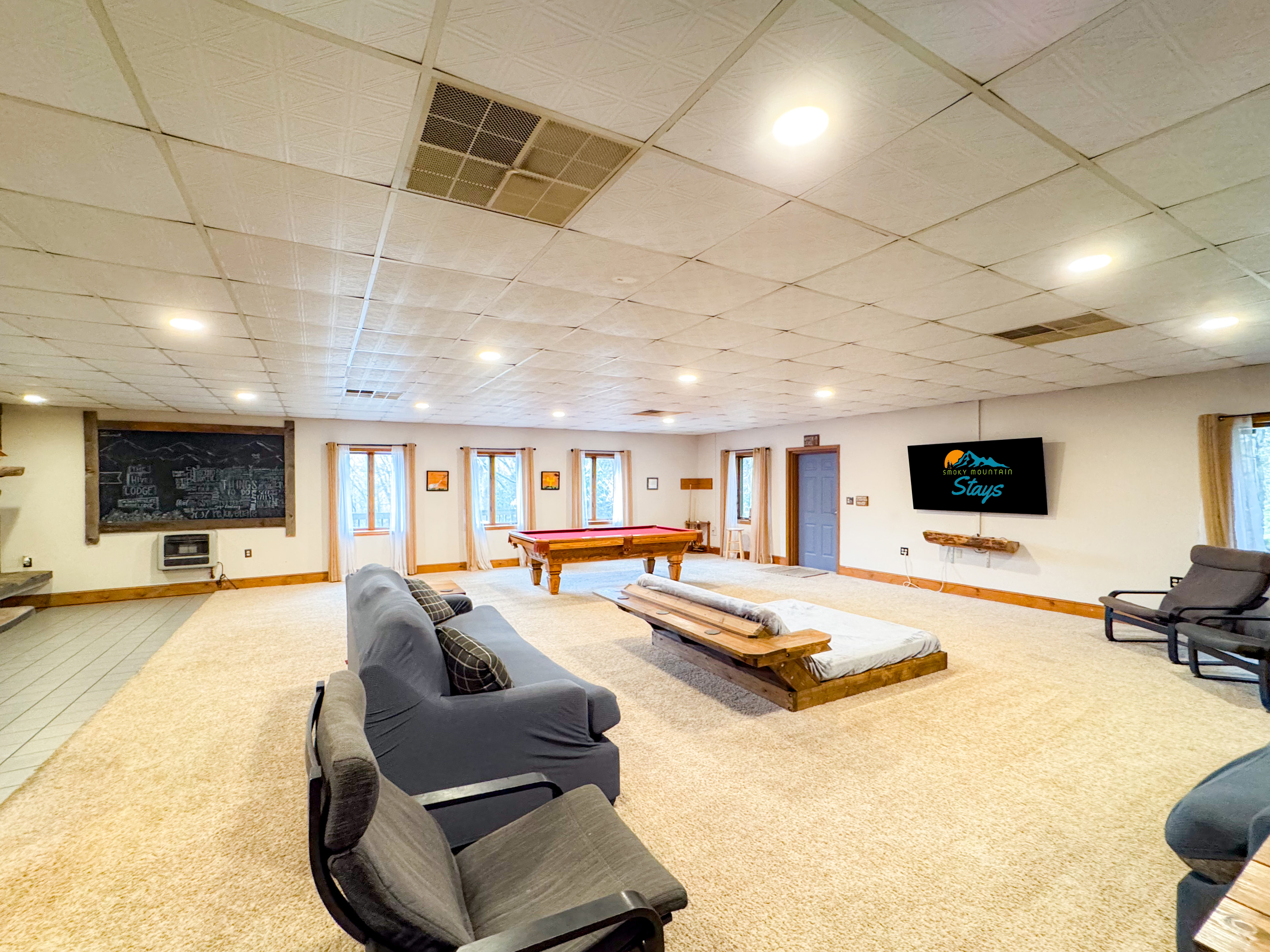 Living Room Complete with 70" TV, lounger, seating and billiards!