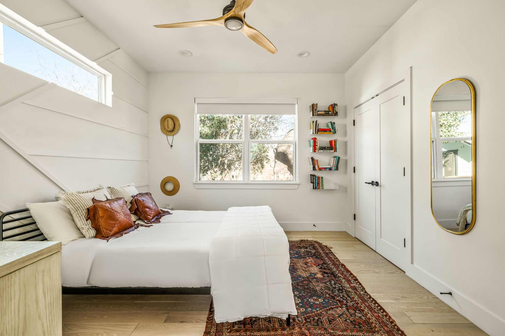 Bright primary bedroom featuring a comfortable king bed and natural light
