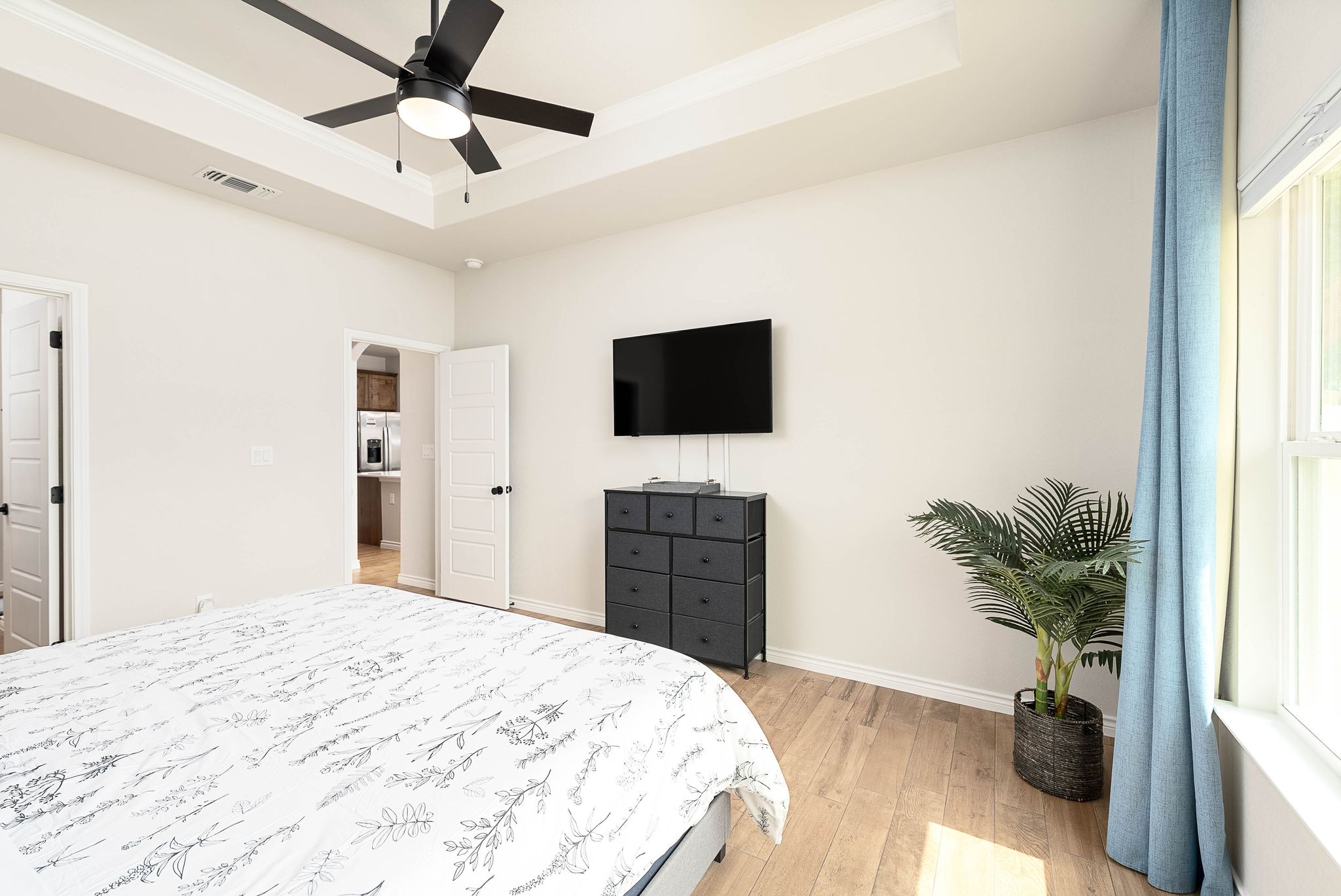 Master bedrom with a king size bed. The cordless  blinds can allow you to slide the blind from the top and or bottom to change the amount of outdoor lighting you desire and  privacy.