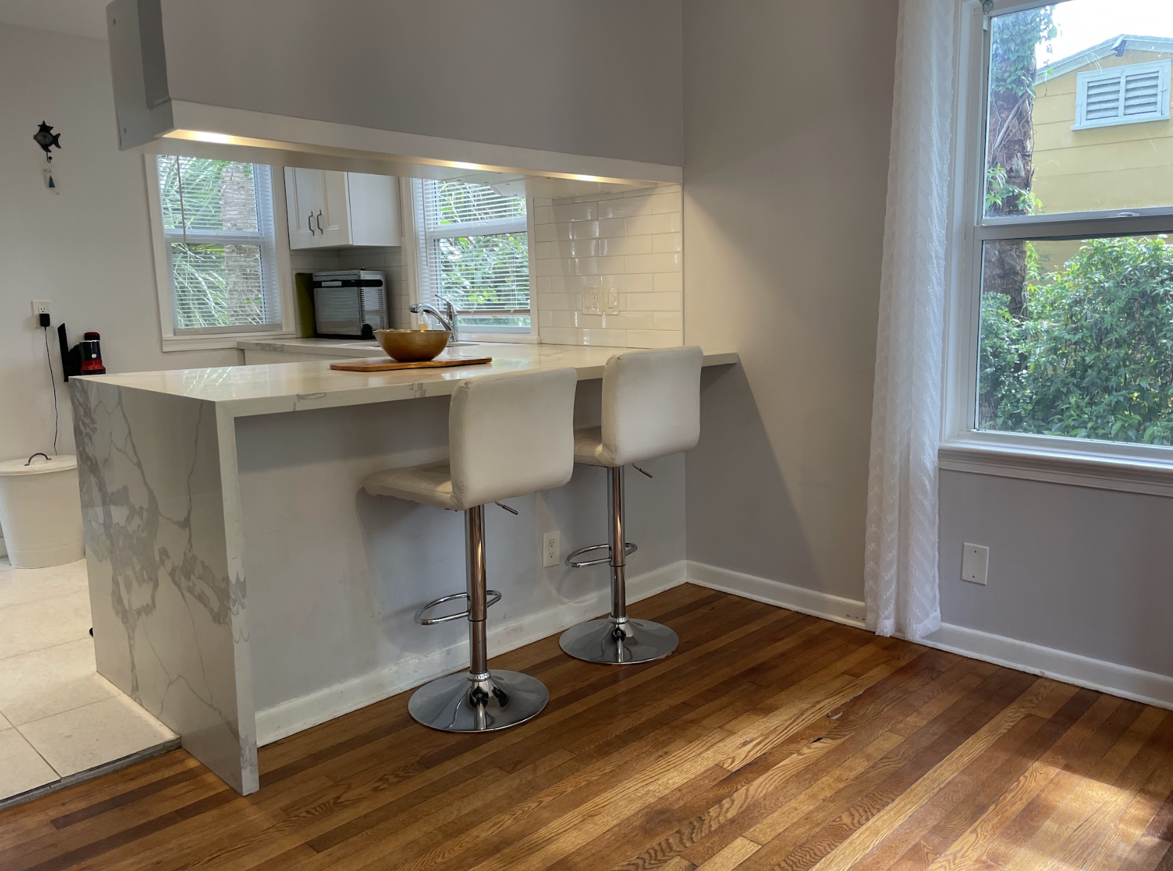 Two counter stools sit in the kitchen, a convenient place to enjoy coffee or breakfast.