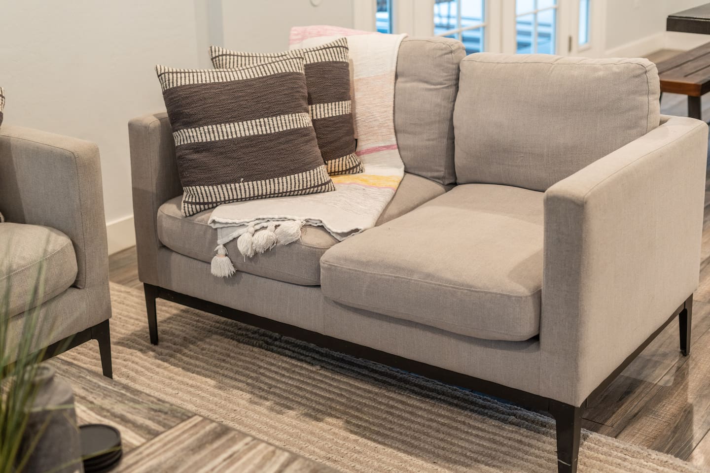 Unwind in this beautifully designed living room with comfortable seating, bold wall art, and a flat-screen TV for your entertainment needs.