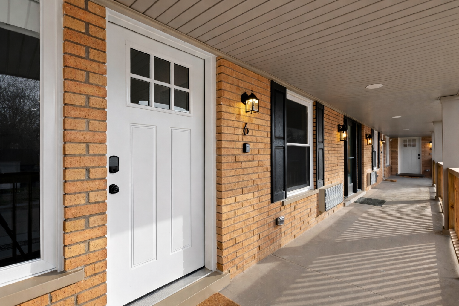 Welcoming private entrance with covered walkway and exterior lighting—easy access, added privacy, and a great first impression.