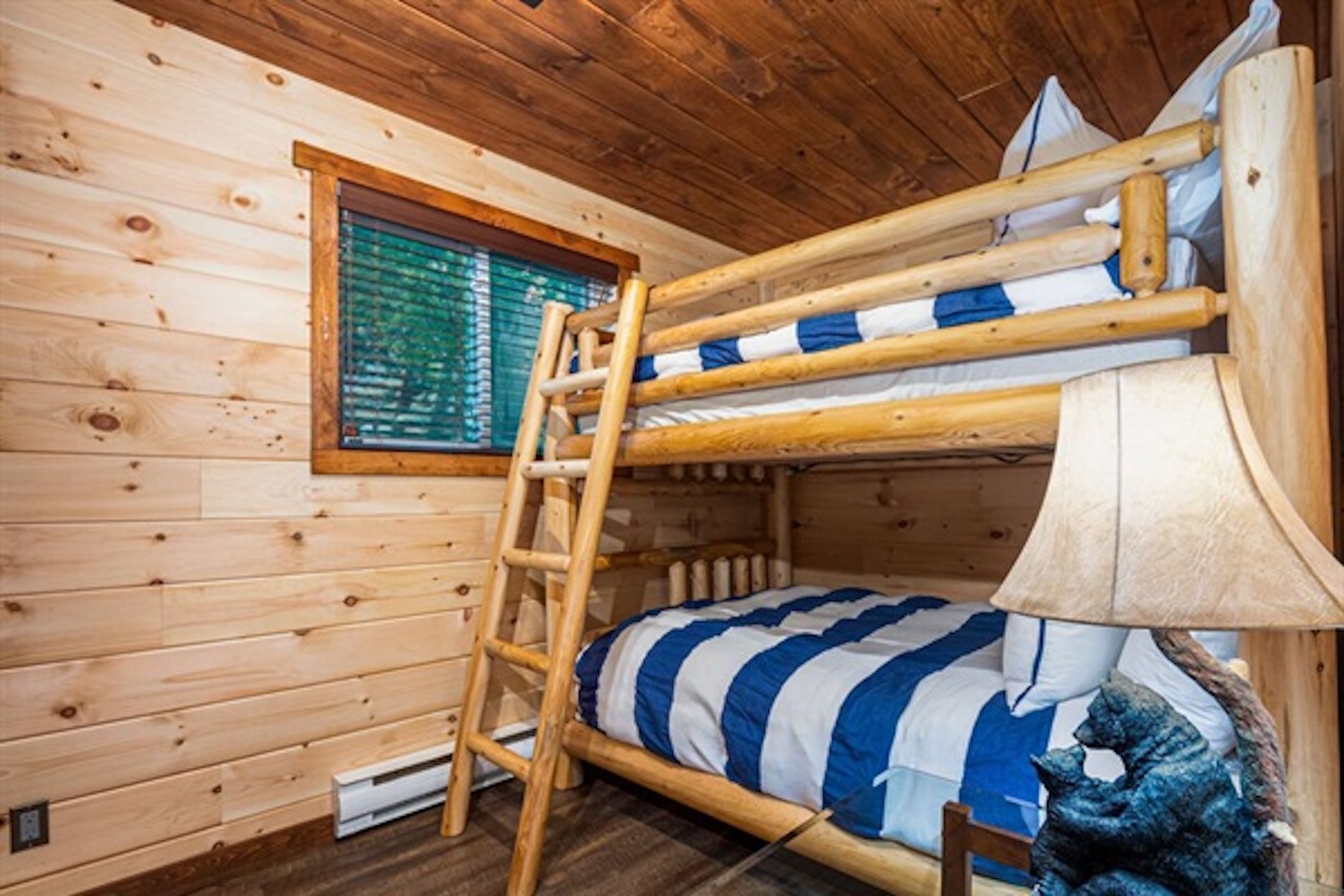 Bunk room with multiple sleeping spaces and natural wood interior