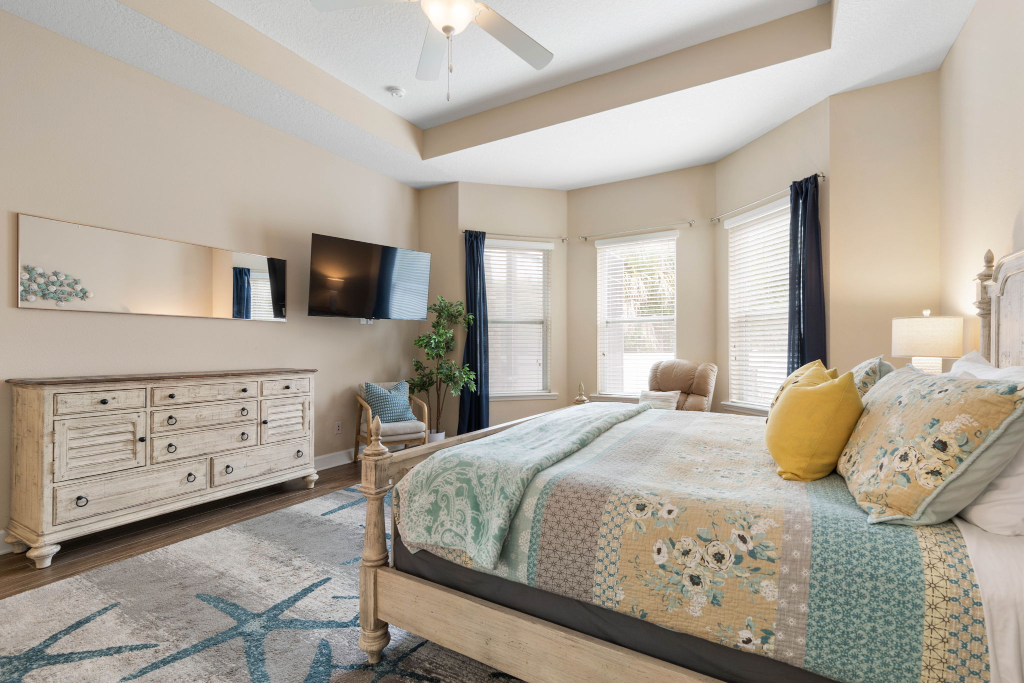 Wake slowly in this serene king suite, stretch out with sunlight filtering through the windows, and end the night with your favorite show and a deep exhale—your own quiet retreat after long beach days and even longer, happier memories.