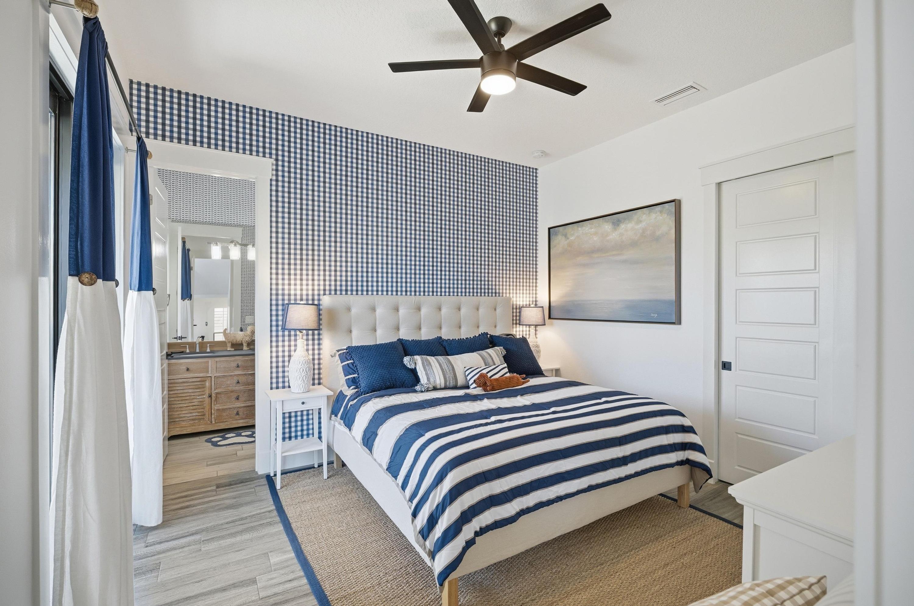 Coastal comfort, perfected 🌊🛏️
Drift off in this serene blue-and-white bedroom with crisp linens, soft lighting, and a private en-suite bath—your own peaceful retreat after a day at the beach.