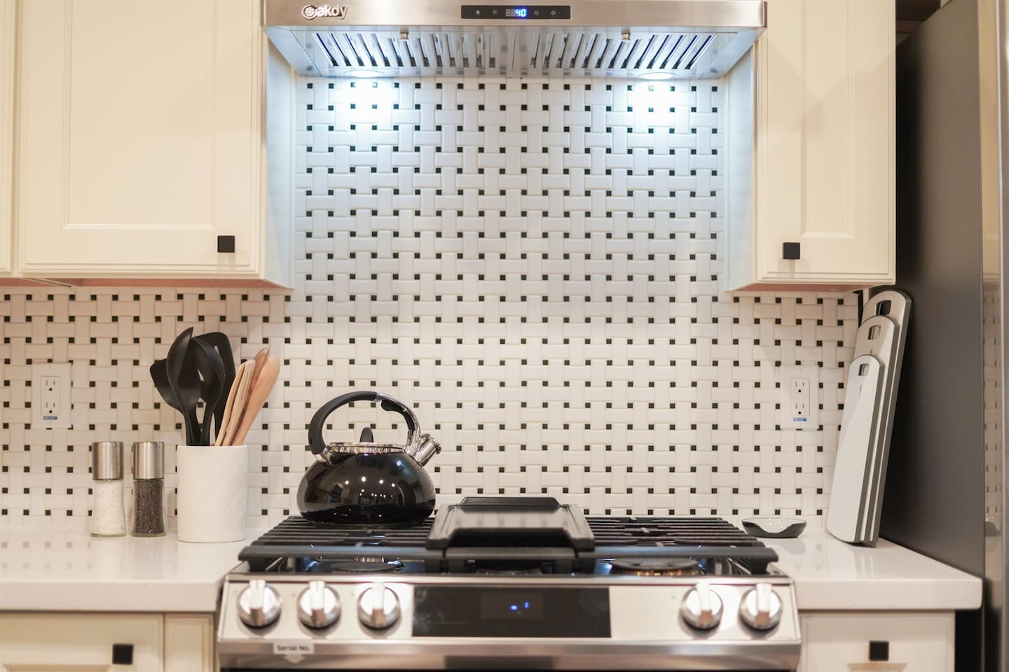 Cook with ease on the gas stove, equipped with kitchen spoons, a chopping board, and a kettle, providing everything you need for delicious meals and tea time.