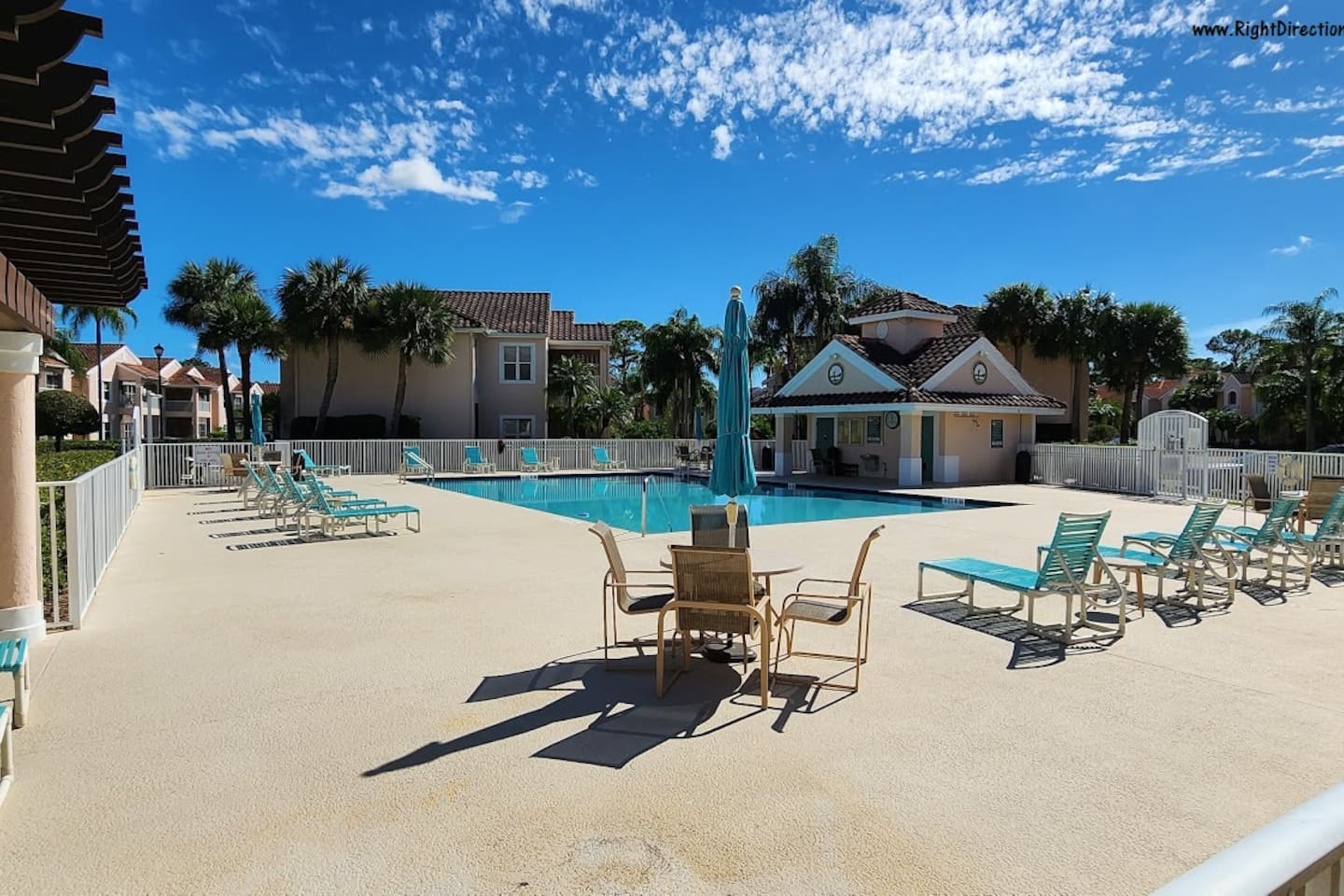 Community pool area with lounge seating, shaded spaces, and a relaxing Florida atmosphere.