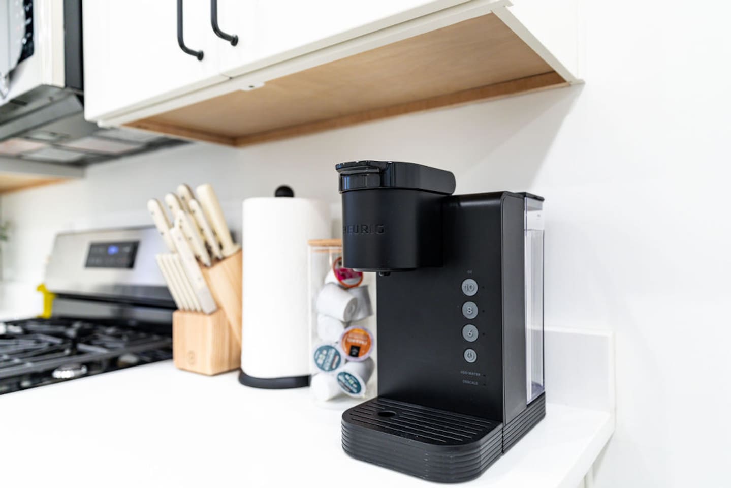 Coffee maker and knife set in the kitchen, providing everything you need for your morning brew and meal prep.