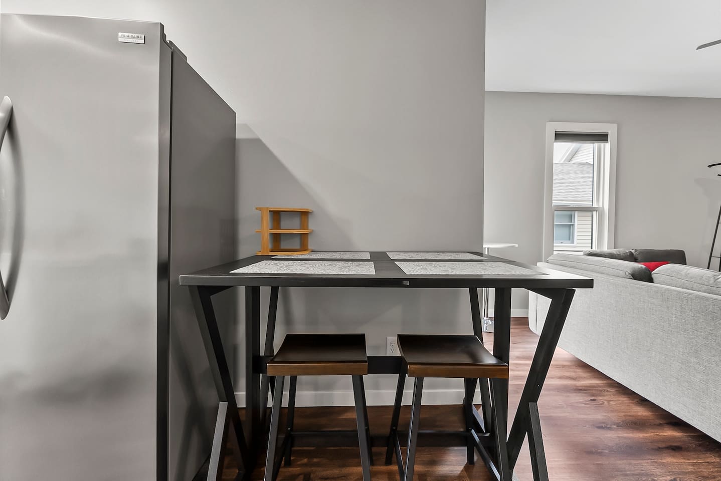 Simple and practical dining space with seating for four, perfect for meals or casual gatherings.