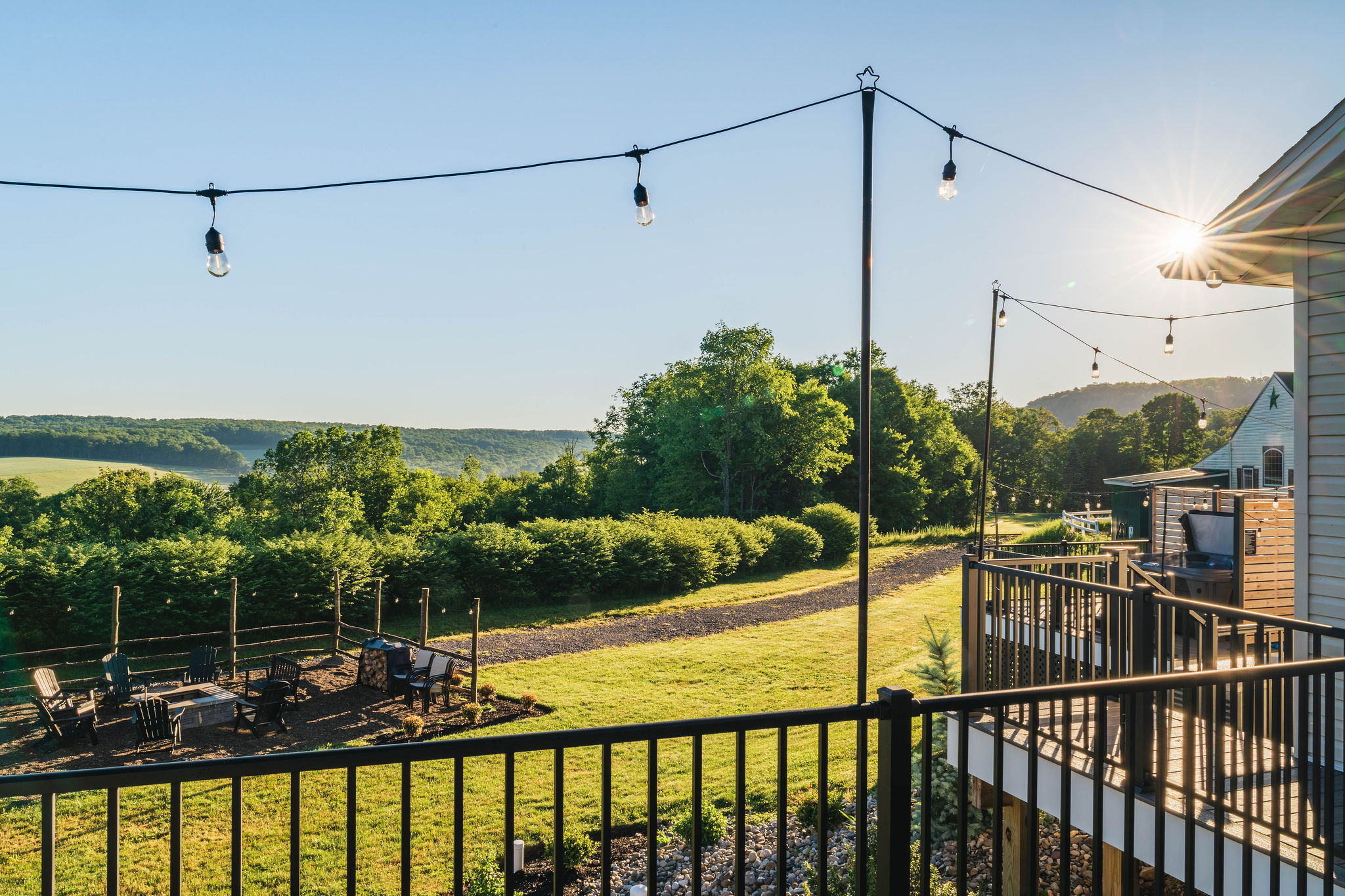 ✨ The deck at golden hour — string lights, vistas, and easy evenings.