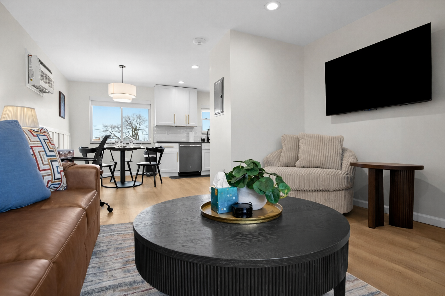 Bright open-concept space with modern kitchen, cozy living area, and smart TV—perfect for relaxing, dining, and enjoying a comfortable stay.