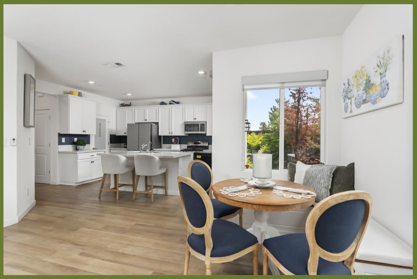 Dining nook with round table seating, bright window views, and open flow into the kitchen for easy meals or coffee.