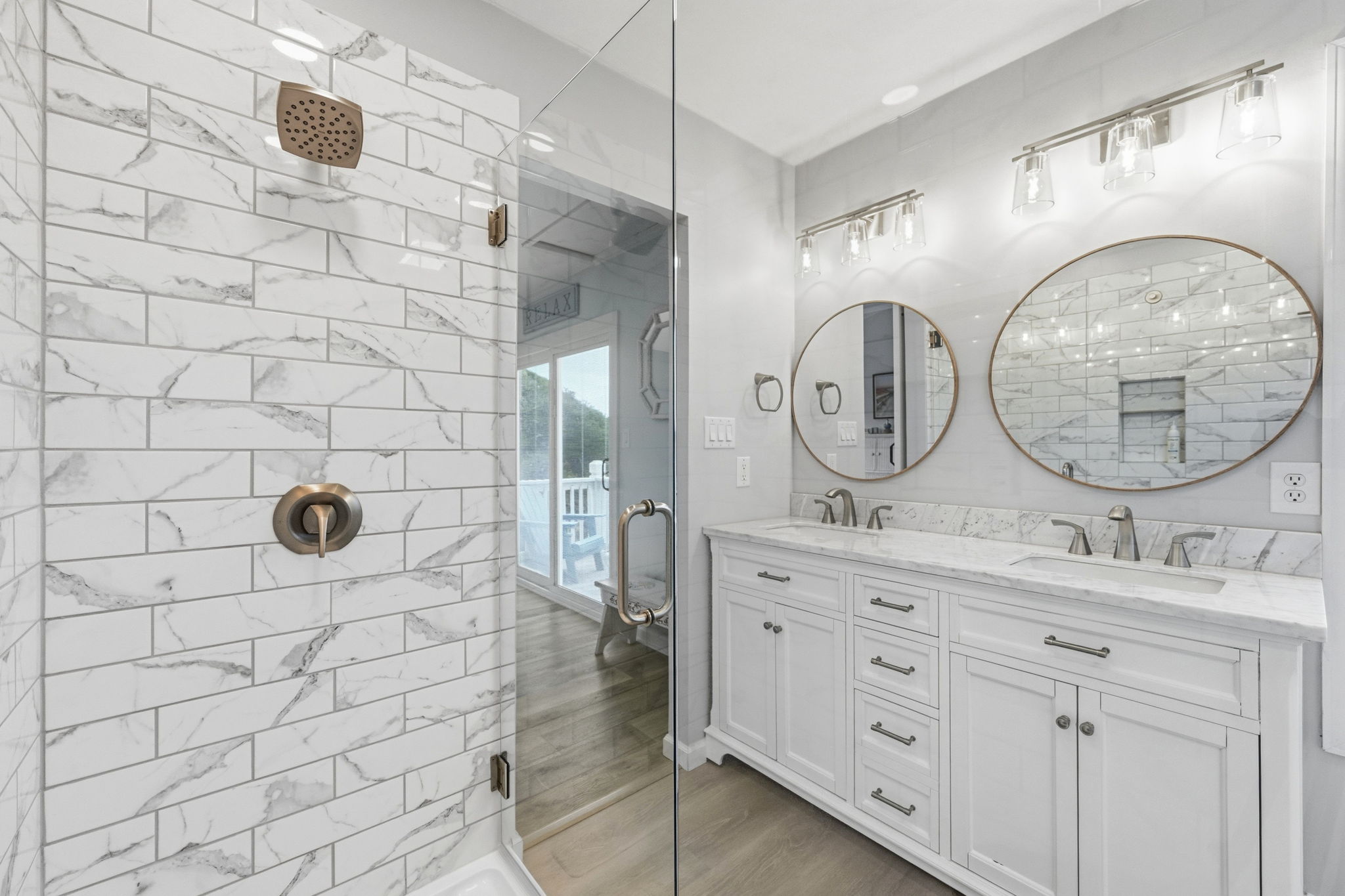 Enjoy a sleek, glass-enclosed shower that feels bright, modern, and spa-like—perfect for refreshing after a day at the beach.