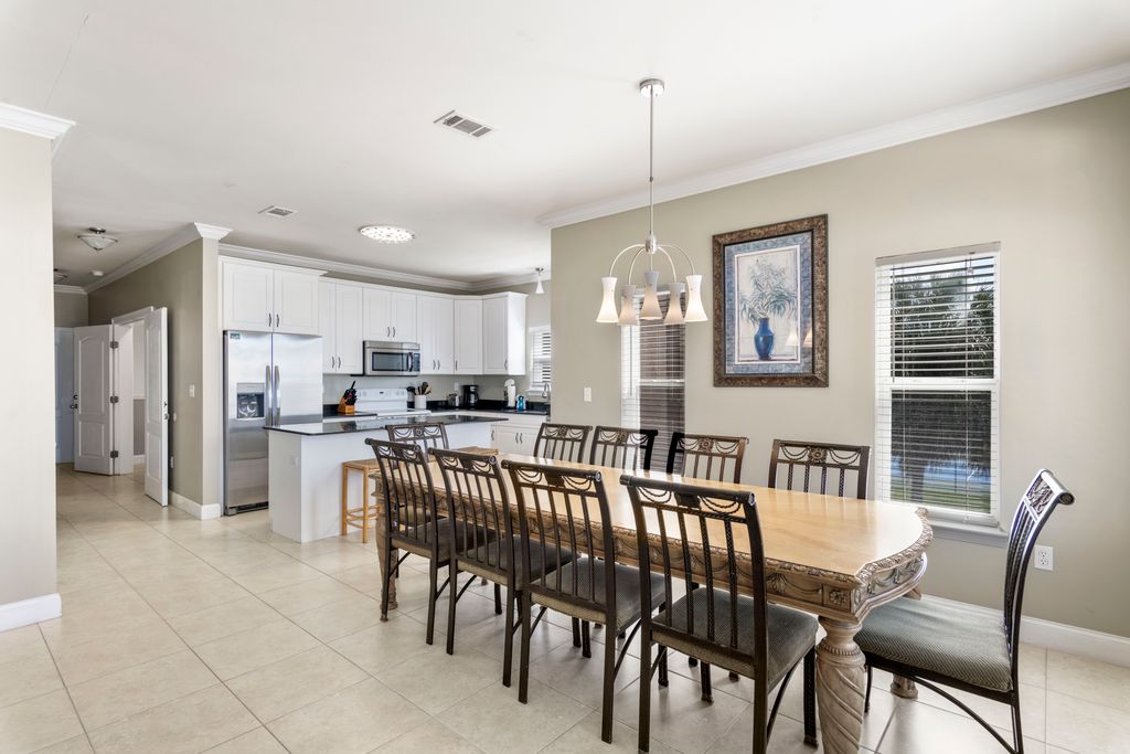 Second Floor: Dining Area– Spacious, fully equipped kitchen featuring an island with addition seating, perfect for family meals.