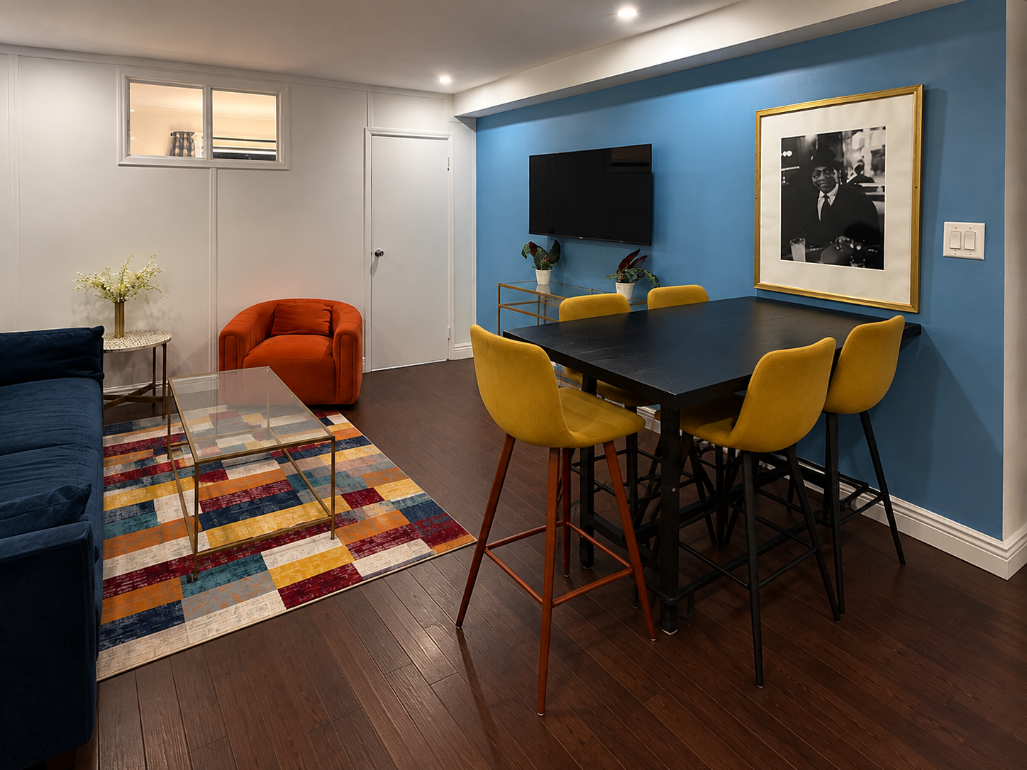 Comfortable living and dining space with flat-screen TV and seating for five — Little Italy NYC apartment near SoHo.