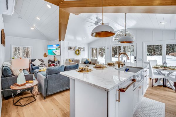 Enjoy a bright and cozy winter escape in this newly renovated cottage. Large windows showcase peaceful snowy woods, filling the space with soft natural light.