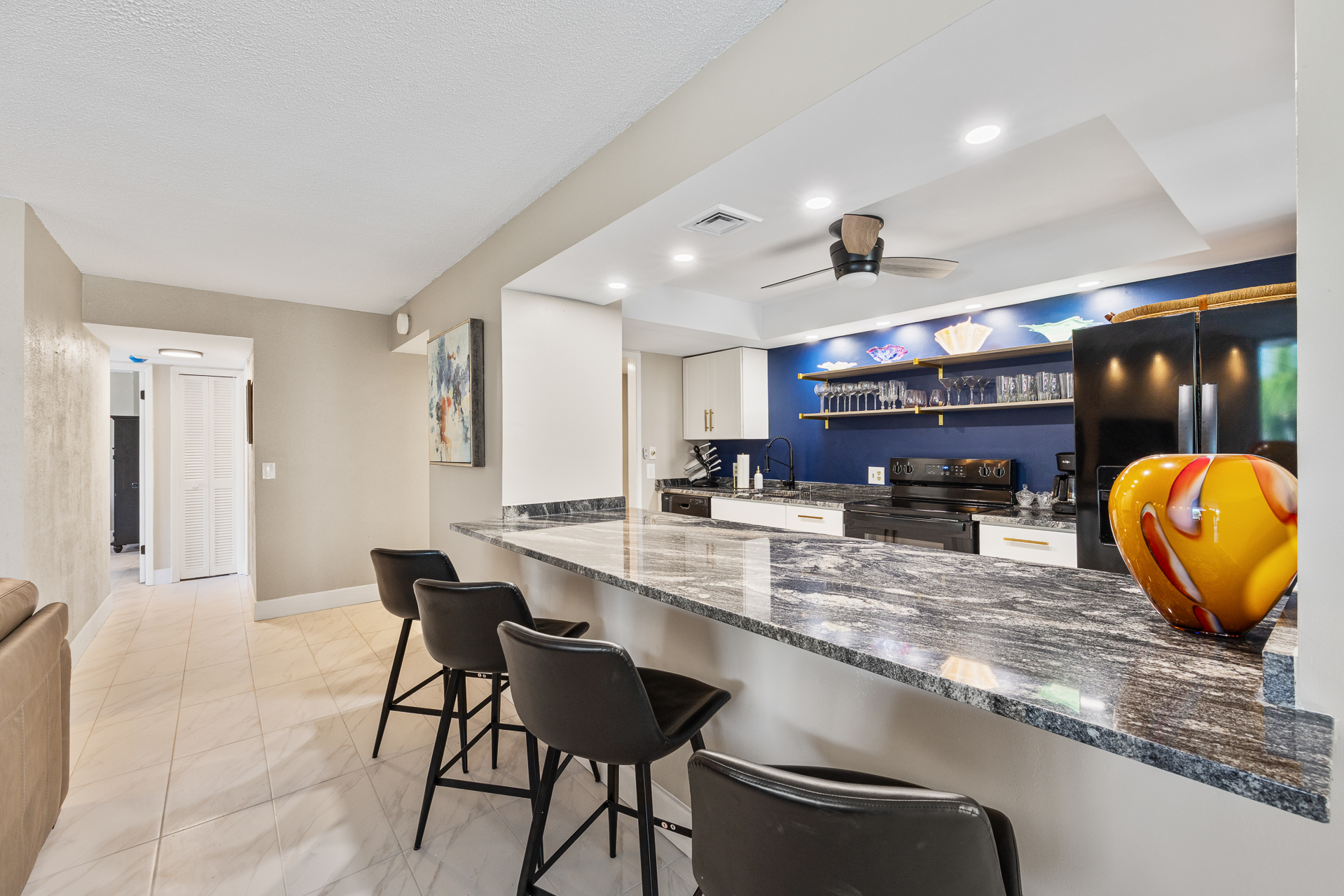 Fully stocked kitchen with cookware, plates, utensils, and all your dining essentials — plus a refrigerator with built-in ice maker and water filter.