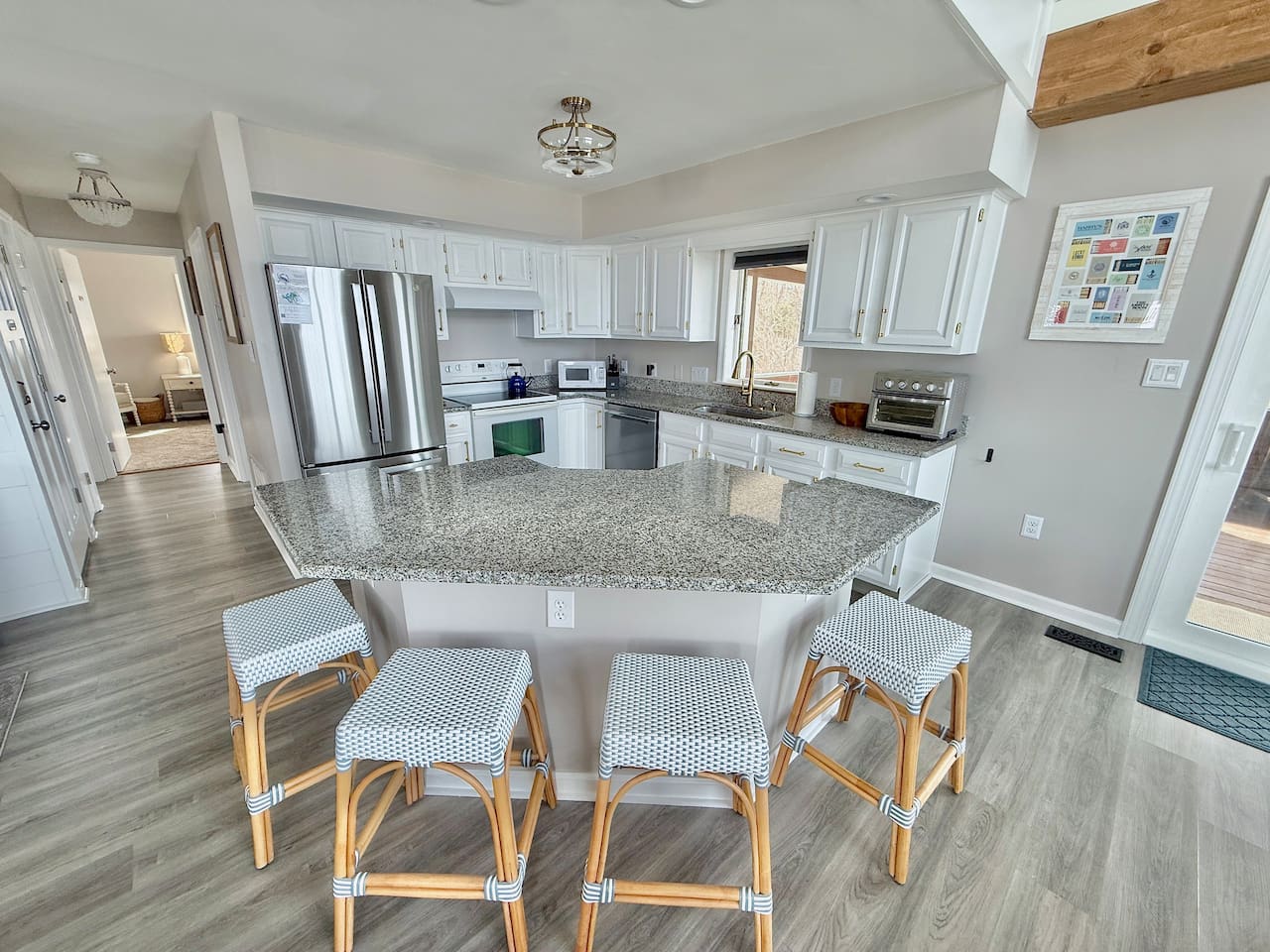 Gather around this modern kitchen island for coffee and conversation. It is the perfect, inviting hub for friends and family to relax and enjoy a memorable vacation together.