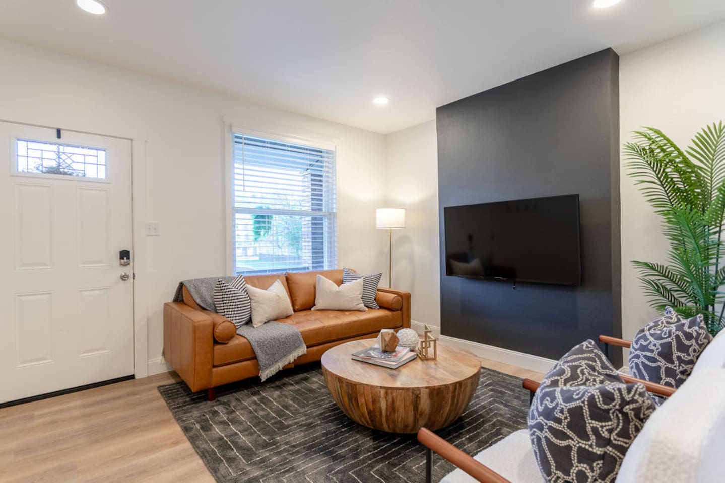 Spacious living area with modern furniture, offering a comfortable and stylish space to relax.