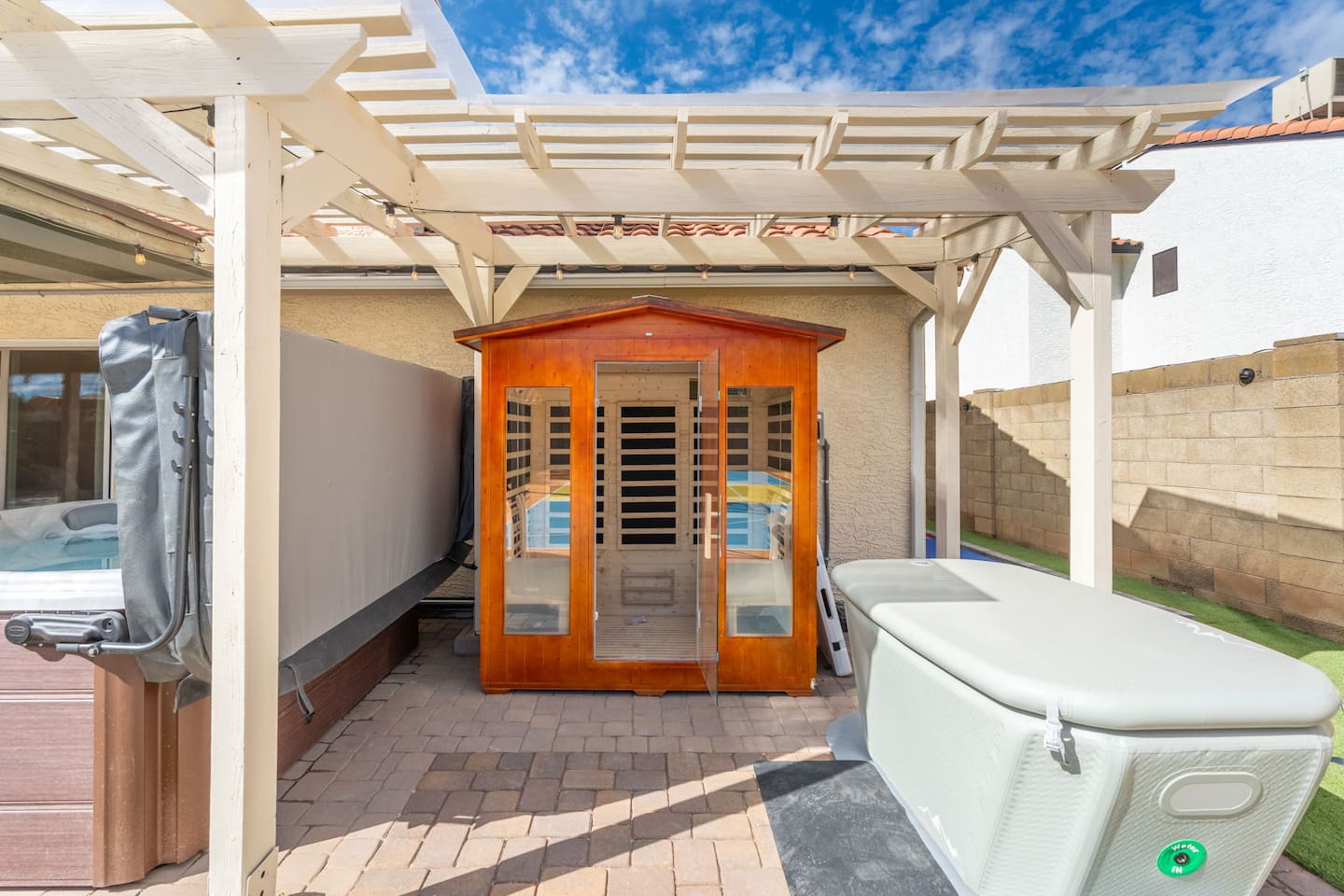 Backyard sauna and spa area with pergola, hot tub, sauna, and cold plunge —the ultimate wellness retreat for relaxation and recovery.