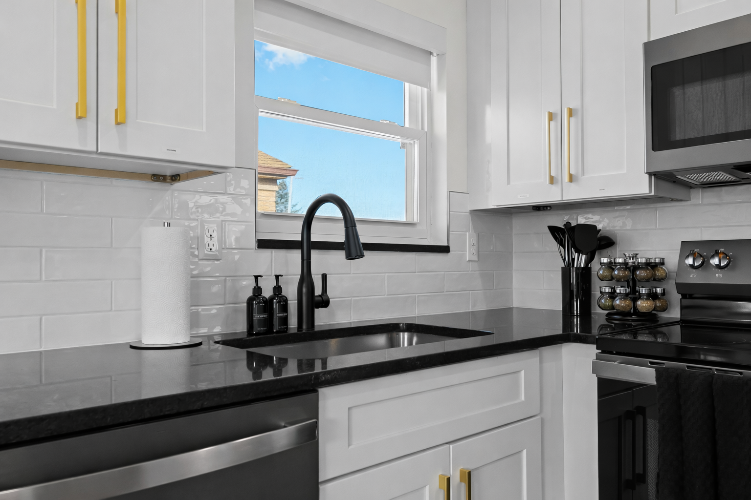 Sleek kitchen with modern fixtures, bright window, and thoughtful details—perfect for effortless cooking and a polished, comfortable stay.