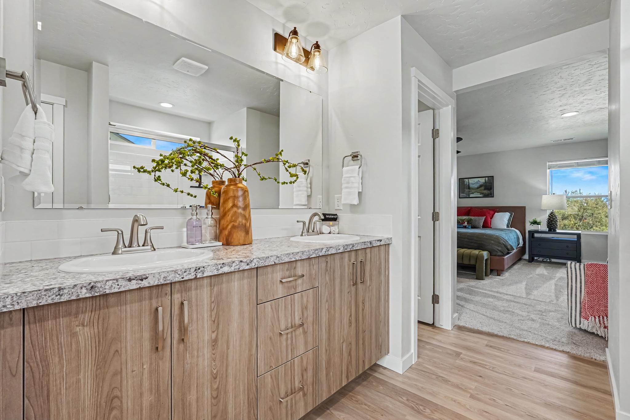 Enjoy the spacious master bathroom, with double sinks and a walk-in shower for comfort, convenience, and a touch of luxury.
