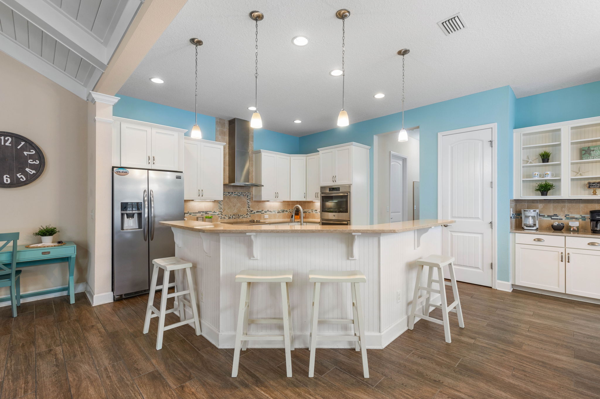 Start the day with coffee at the island, trade beach plans over breakfast, and gather back here for drinks and dinner—this bright coastal kitchen is where vacation stories begin, and where the best ones get told again.