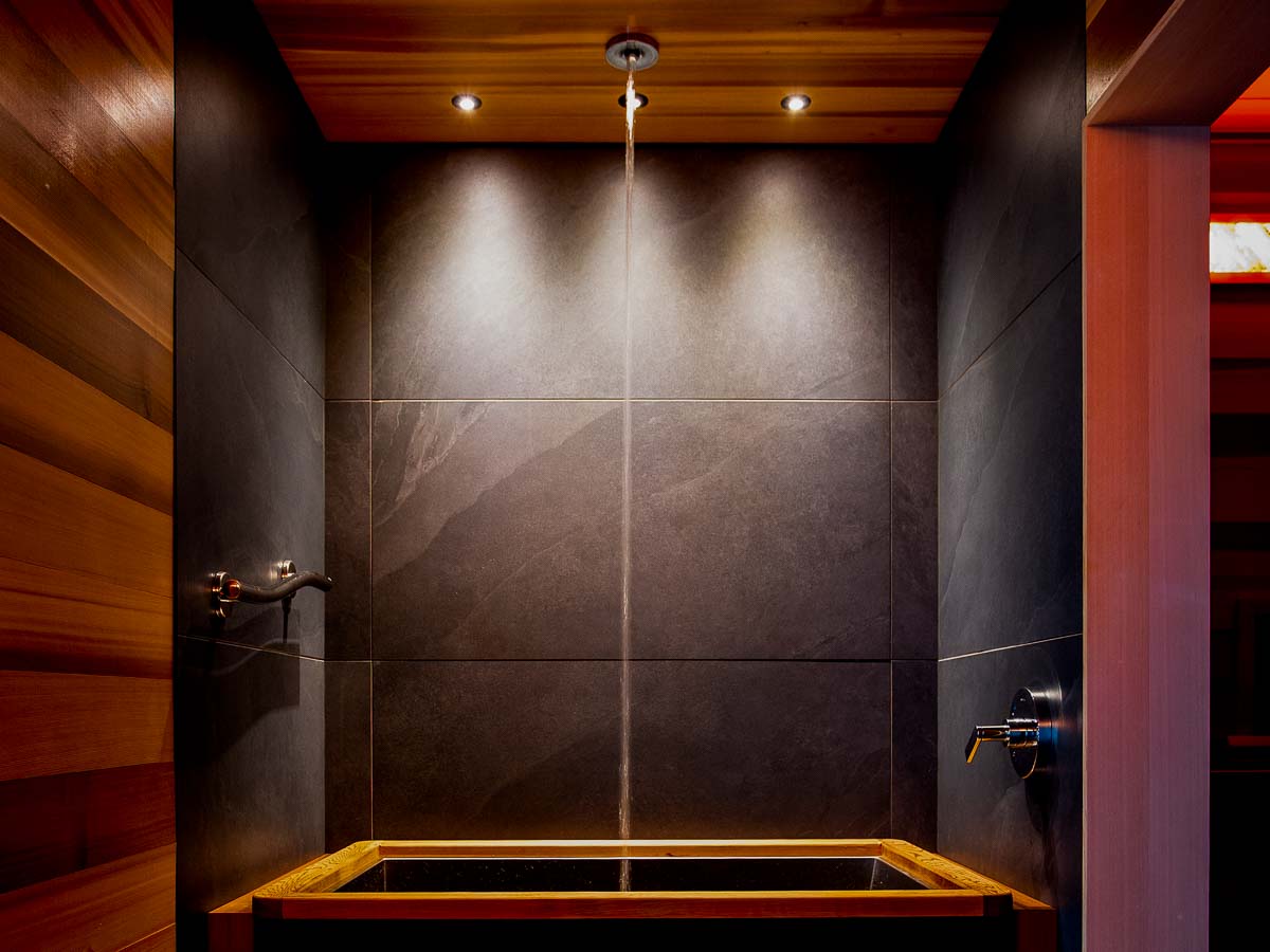Cold plunge at Sunset Falls &mdash; stainless basin with cedar trim, laminar column of Berkshire mountain well water