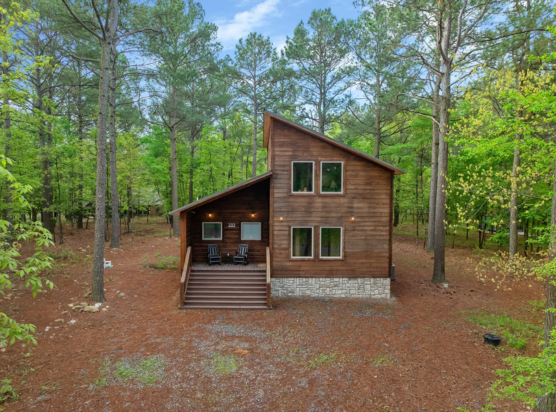 Rustic cabin exterior surrounded by tranquil trees and outdoor beauty