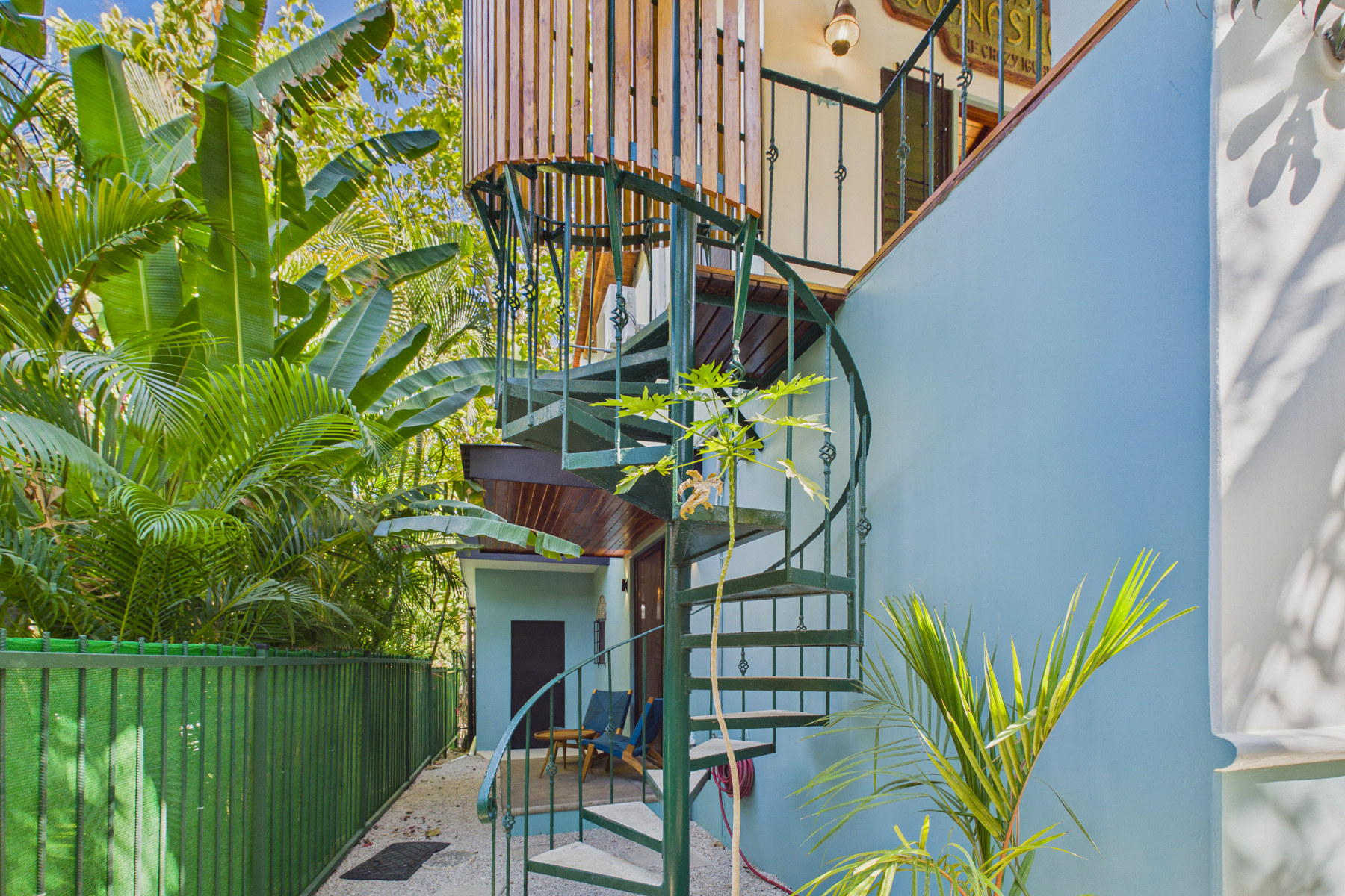 Outdoor covered spiral staircase to upstairs bedroom 5
