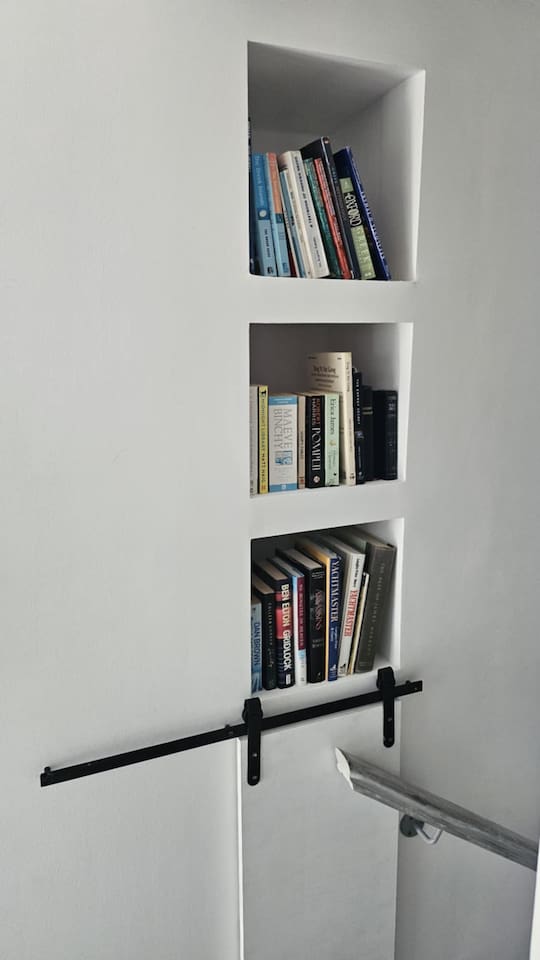 Assorted reading material including Greek language and tour books; a hidden compartment for the vacuum cleaner