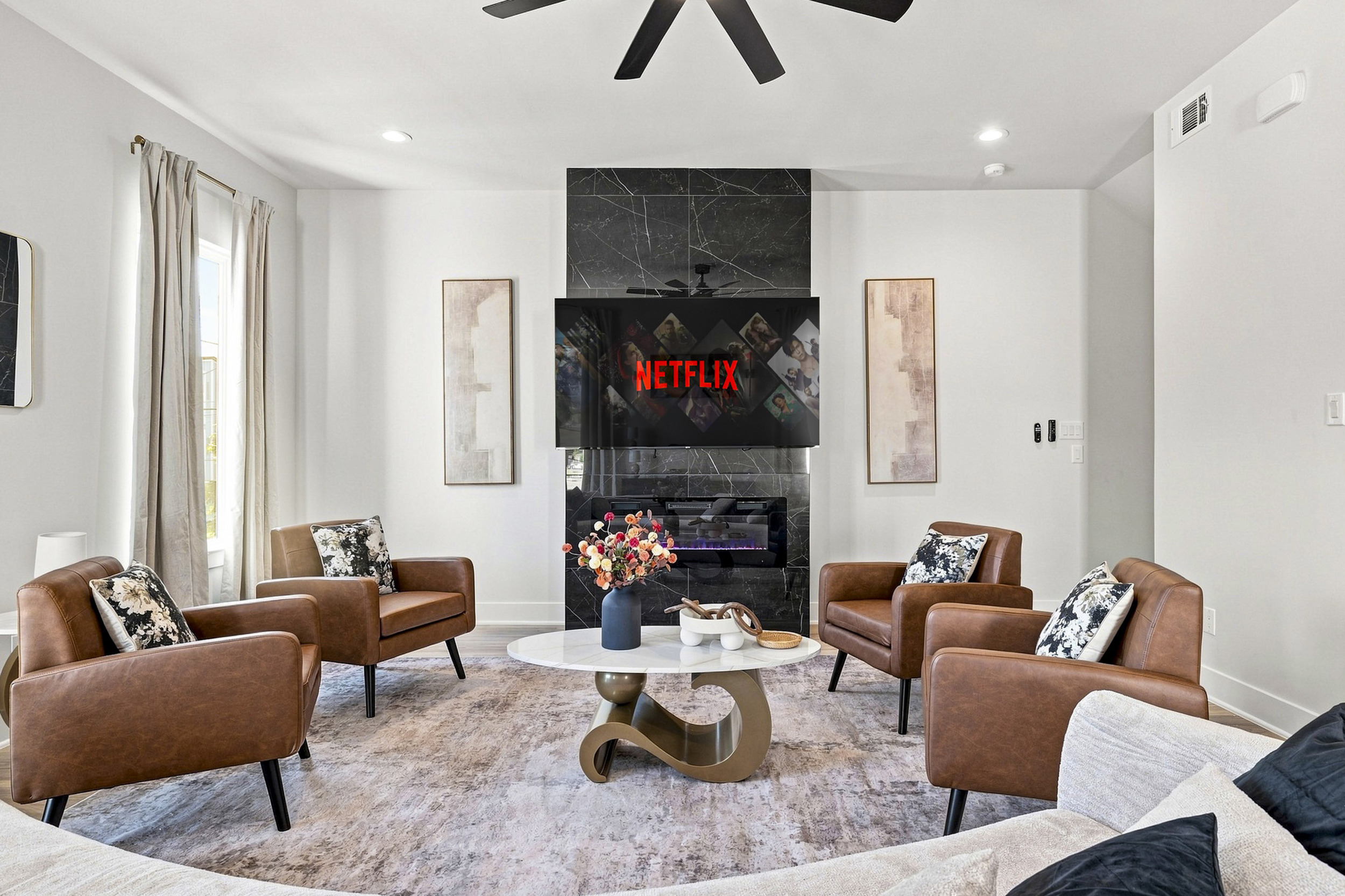 Stylish seating centers around a sleek TV, perfect for movie nights and relaxation!