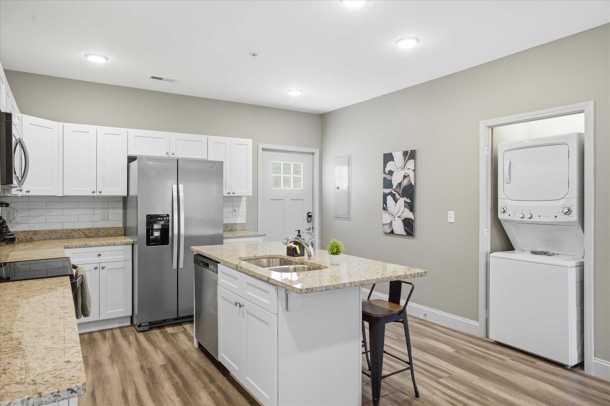 In Unit 2, laundry is right where you need it—easy to throw in a load and keep moving without stepping away from everything else.