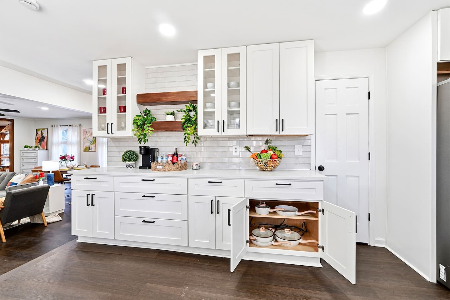 Bright white kitchen with a sleek, extended layout and ample counter space. The long layout offers plenty of countertop space, perfect for cooking, prepping, and everyday meals. Fully stocked with everything you need for a comfortable stay!
