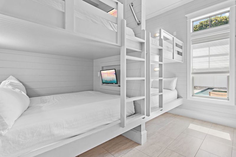 Bedroom 2 (First Floor): Bunk Room with two queen-over-queen and twin-over-twin bunk beds, shared bathroom 