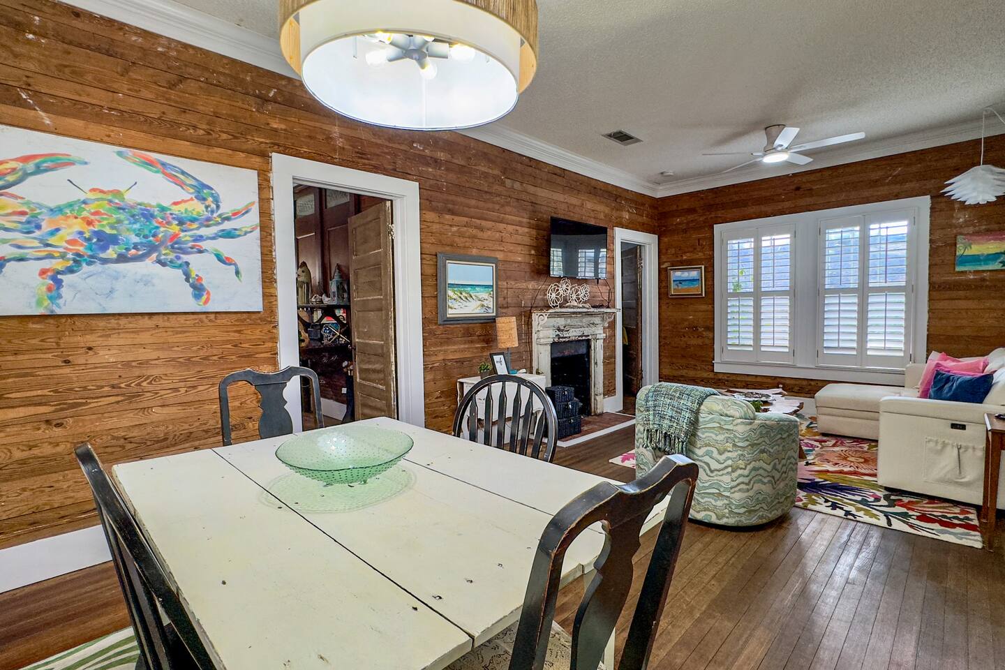 Charming living space featuring wood-paneled walls, vibrant decor, and a welcoming, homey atmosphere.
