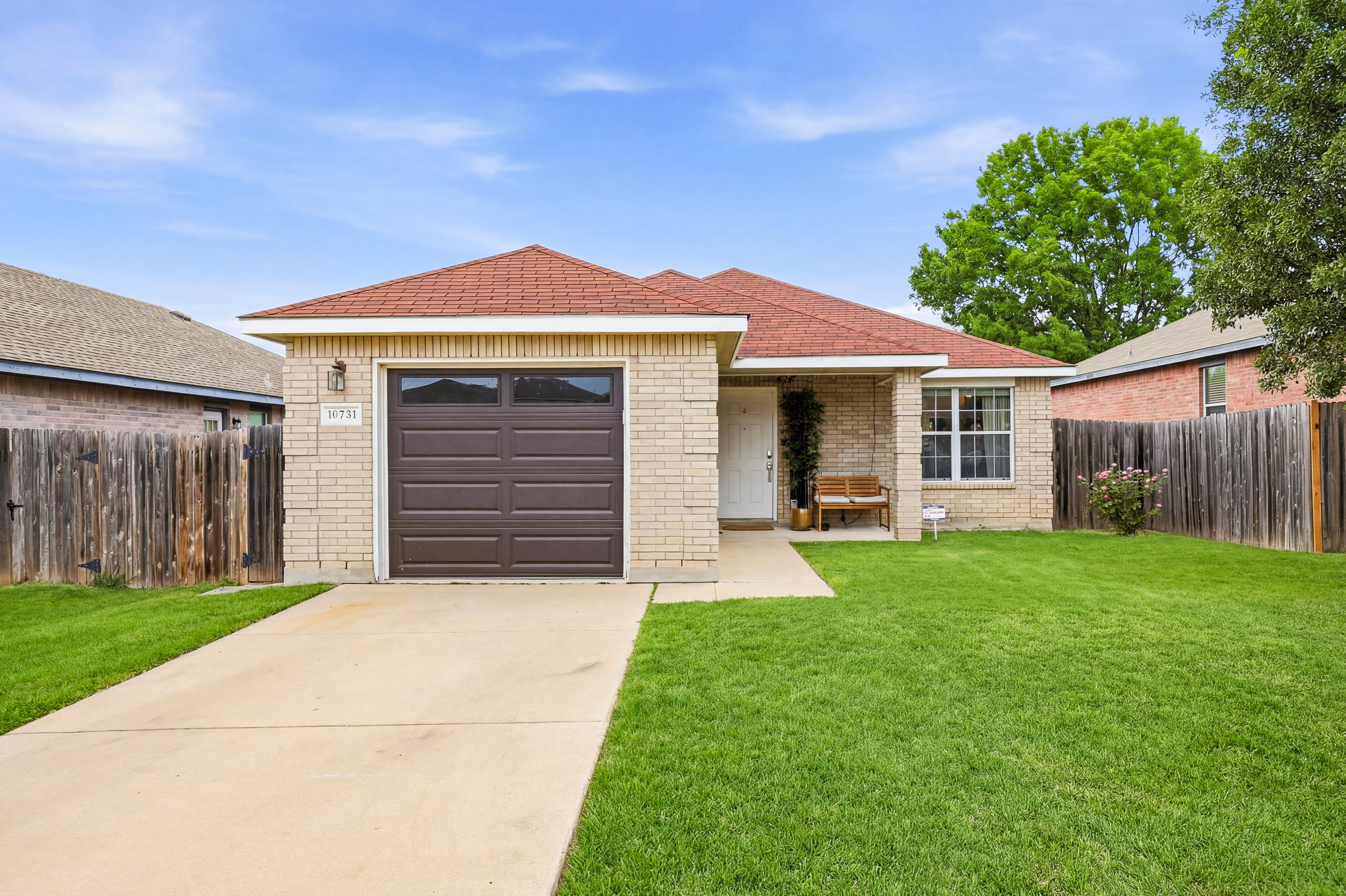 Single-story brick home in Northwest San Antonio with attached garage, manicured front lawn, and fenced yard. Driveway parking plus garage access — up to 4 vehicles total. Minutes from SeaWorld and Six Flags.