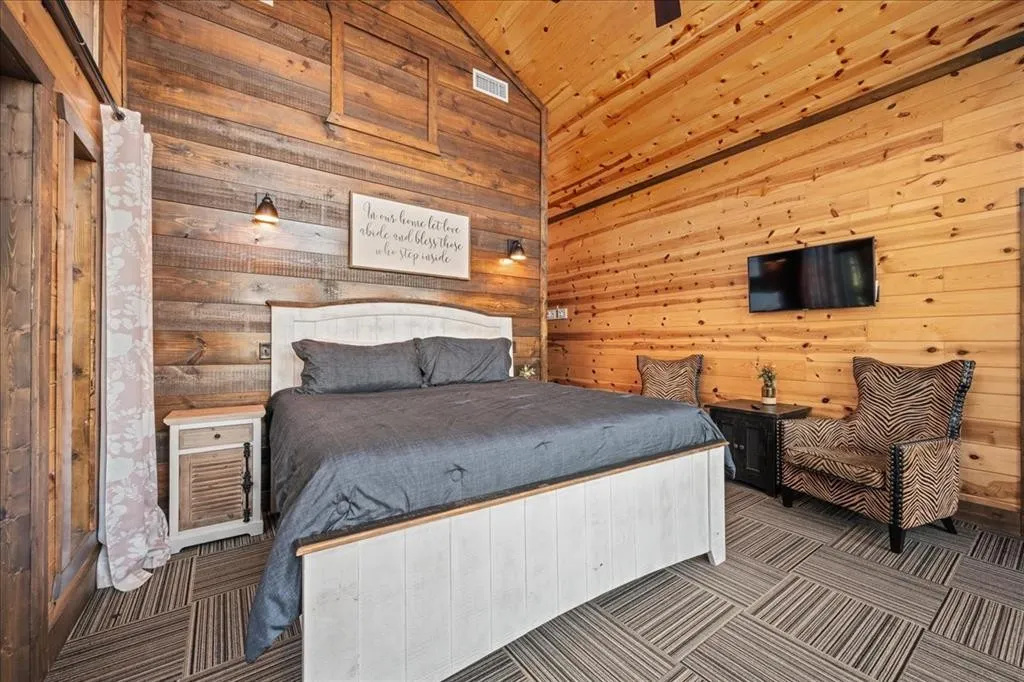 Master bedroom with king bed, smart TV, balcony and mountain views.