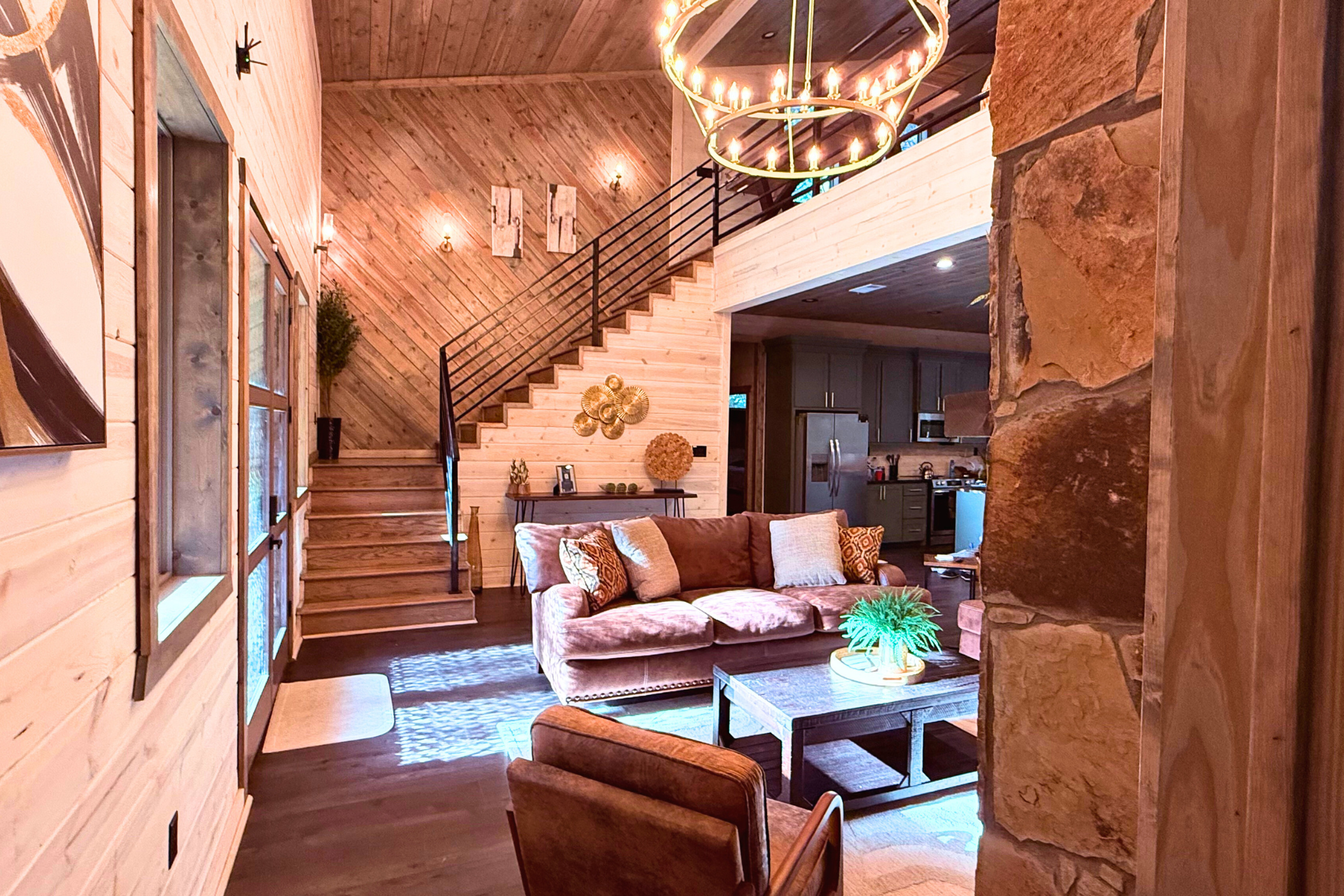 Cozy living room with stone fireplace & nature views