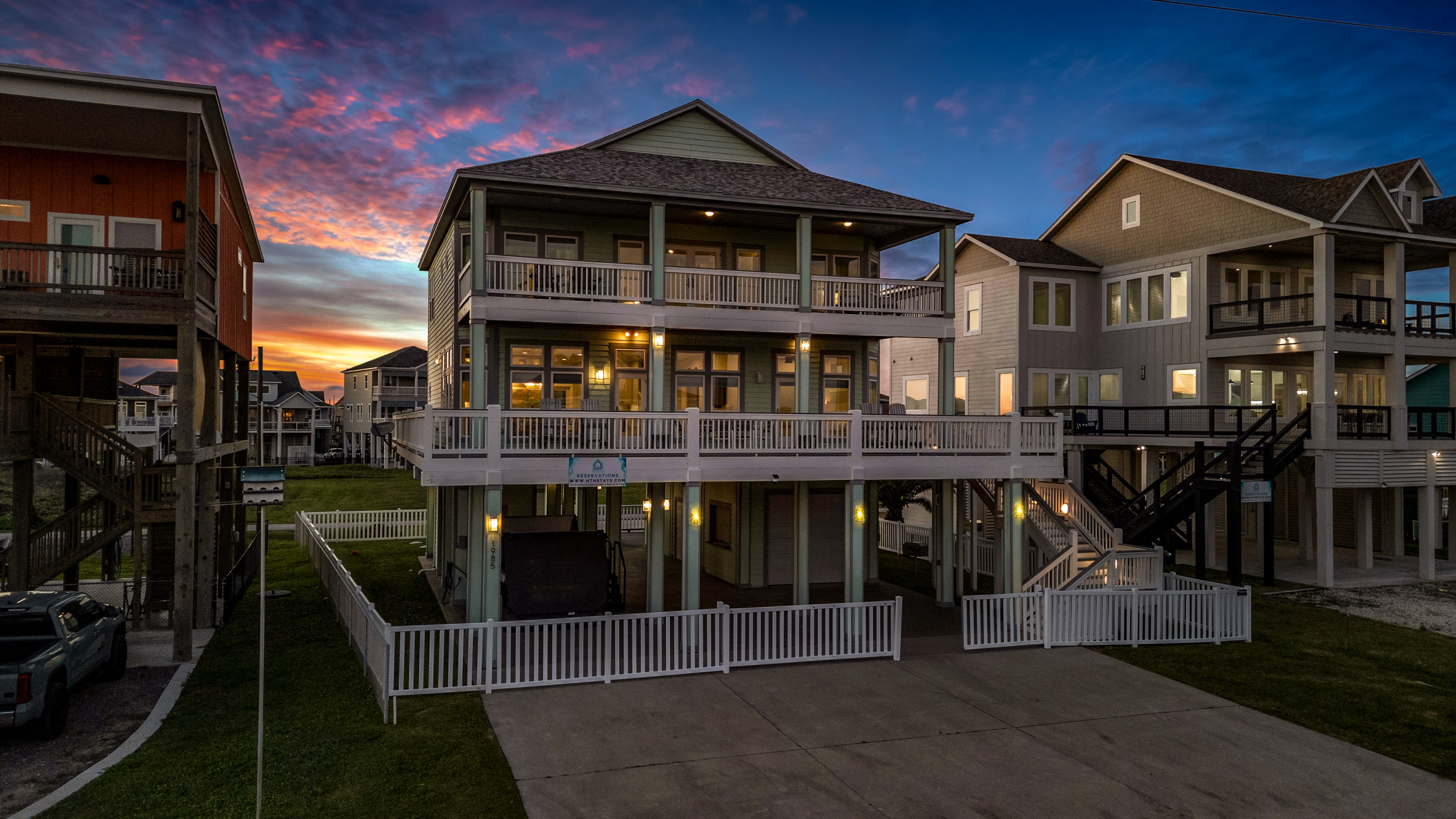 Crystal Paradise Exterior: Enjoy golden sunsets and cool coastal breezes from the home’s spacious upper balconies.