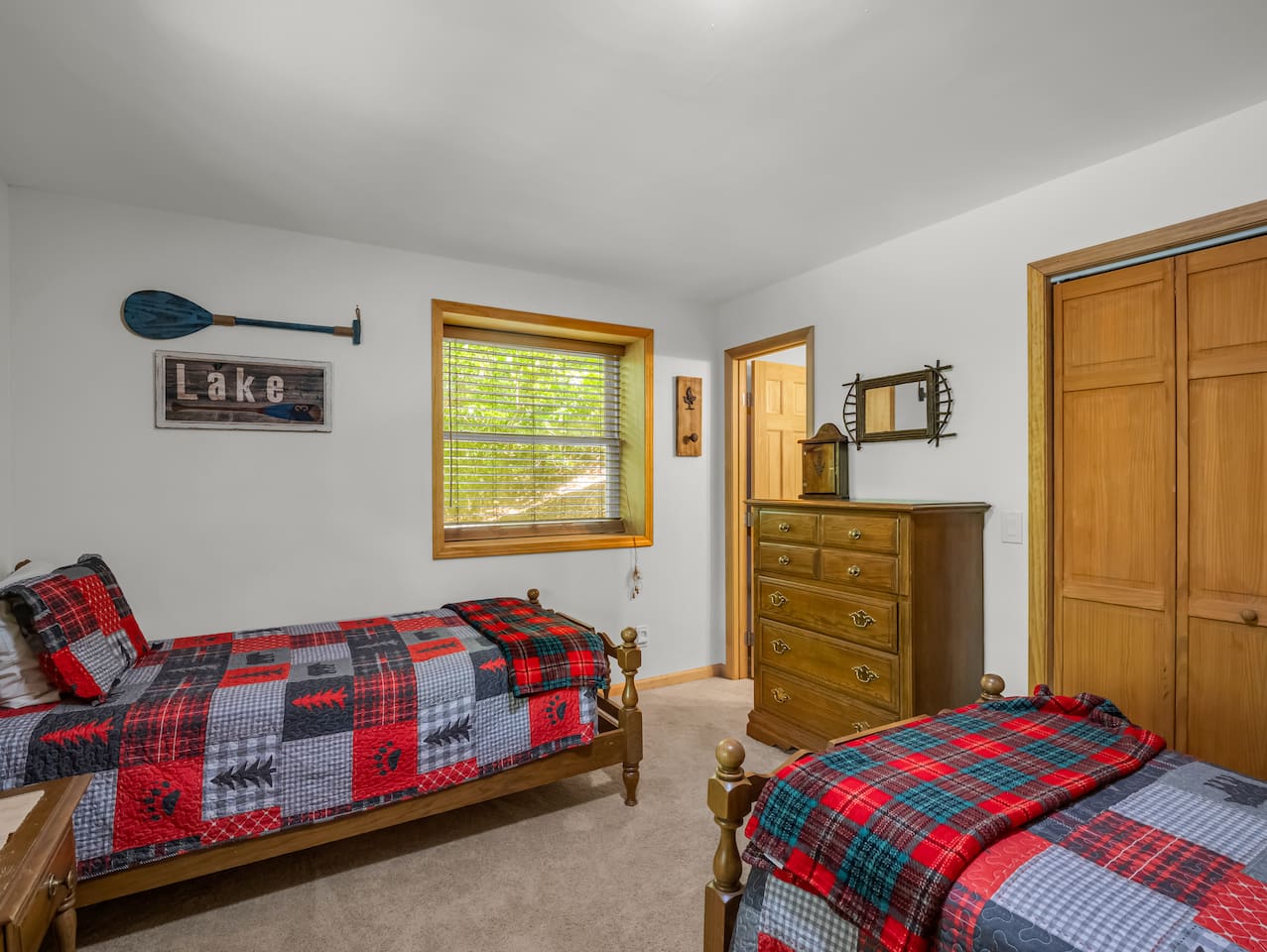 Bedroom in the basement level with two twin-sized beds and a connecting full bathroom 