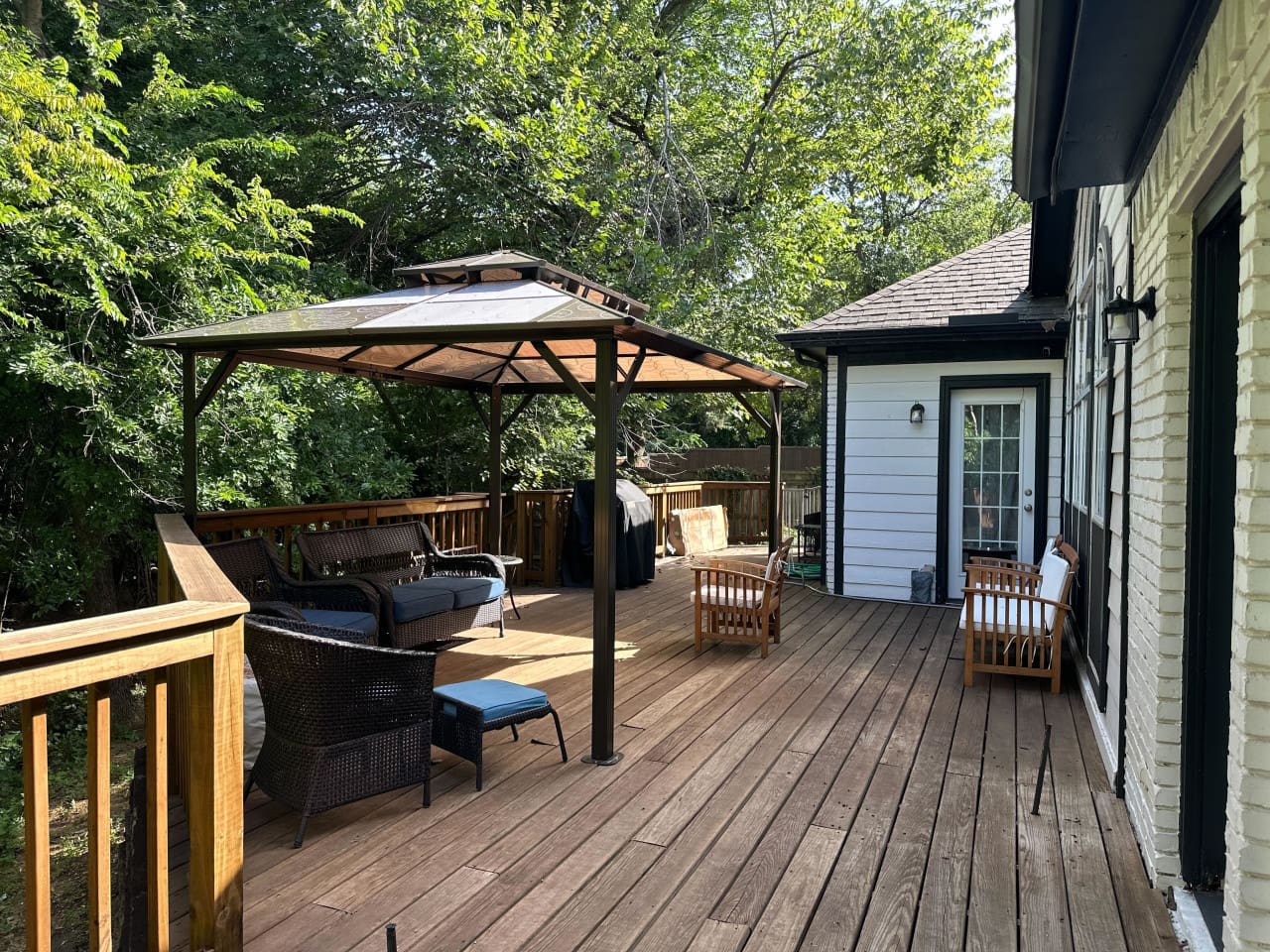Back patio with BBQ gas grill and lots of shaded seating.