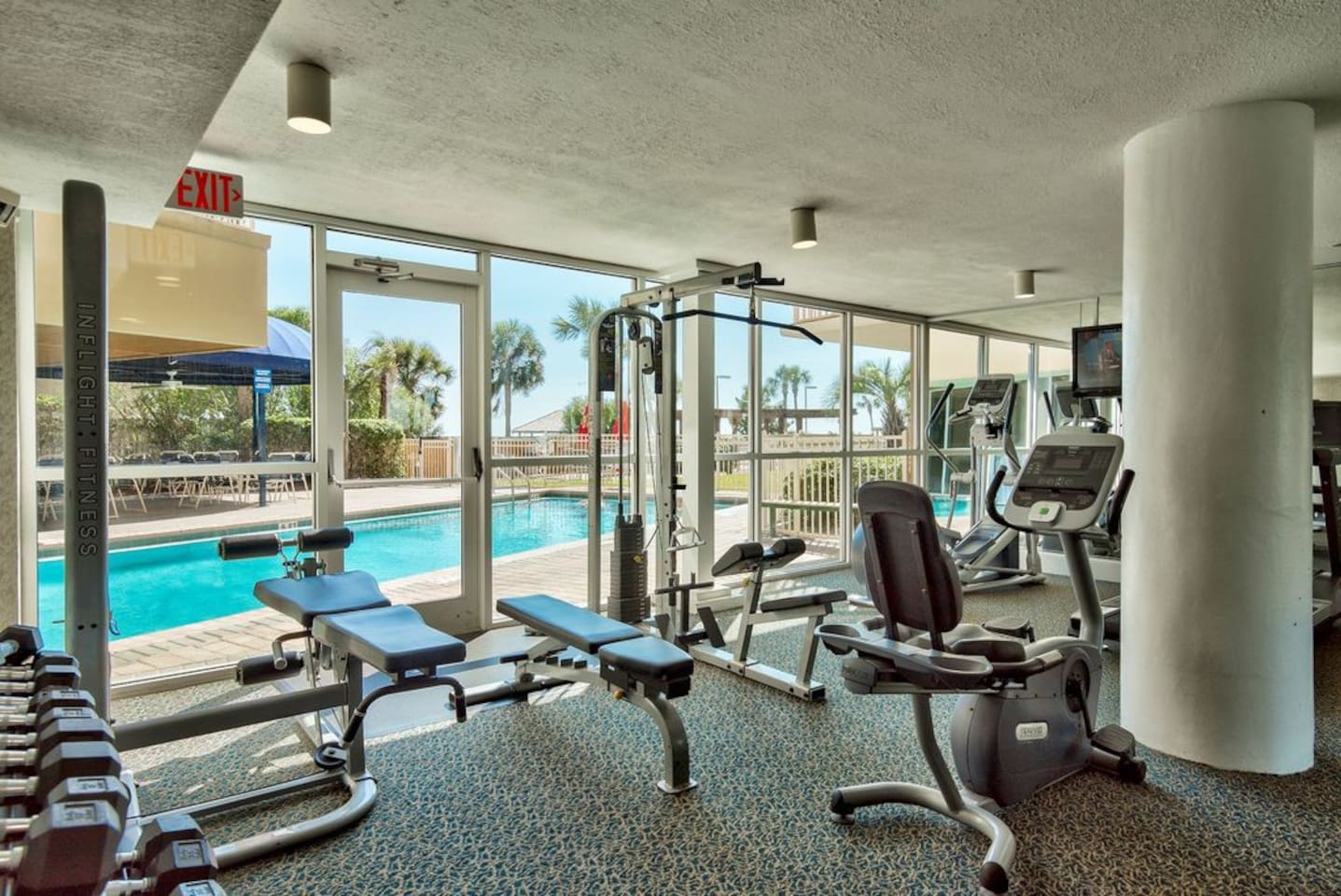 Updated fitness center overlooks pool...