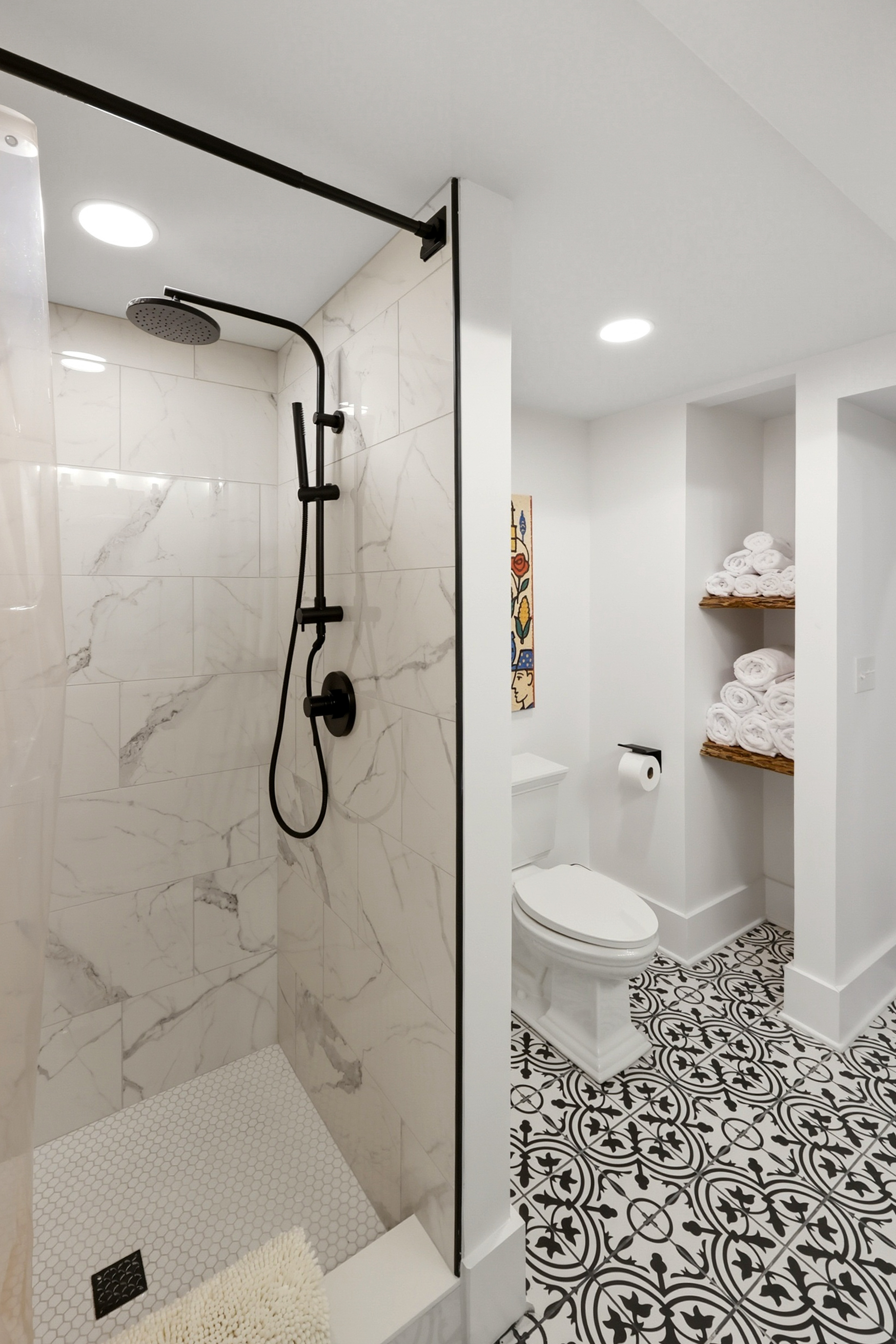 Large, newly remodeled bathroom with double vanity and tile shower.