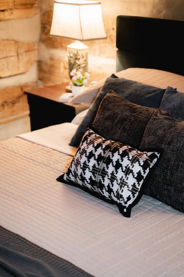 A bedroom with soft lighting and a comfortable bed, perfect for unwinding after a day of adventure.