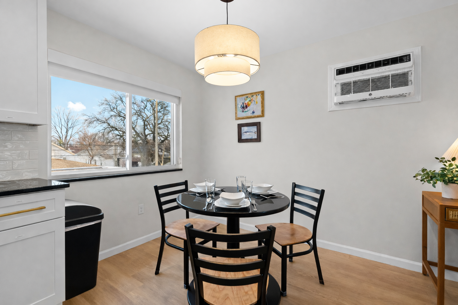 Bright dining nook with modern table seating, natural light, and a cozy atmosphere—perfect for meals, morning coffee, or casual gatherings.