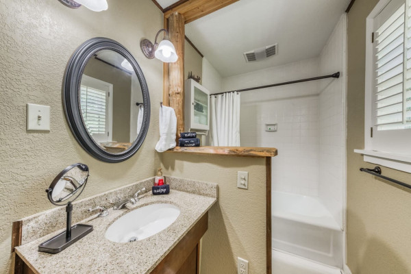 Freshen up in the bathroom, equipped with a sink, shower, and all the essential amenities for your comfort and convenience.