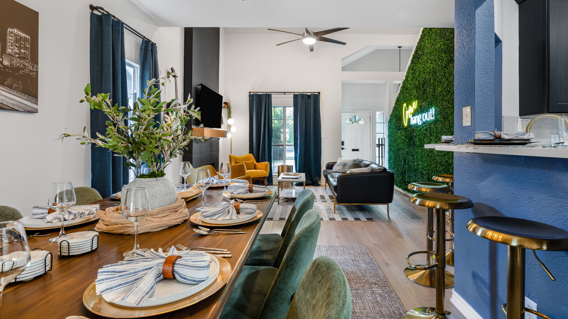 Step into this chic, open-concept haven! Dine in style, then unwind in the cozy living area. A vibrant green wall with a neon sign adds the perfect touch of modern flair and charm!